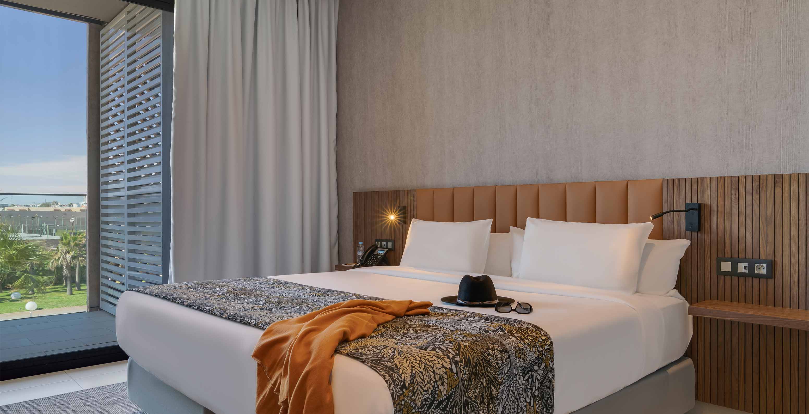 Die Premium-Suite im Pestana Casablanca hat ein Schlafzimmer mit Doppelbett und Balkon