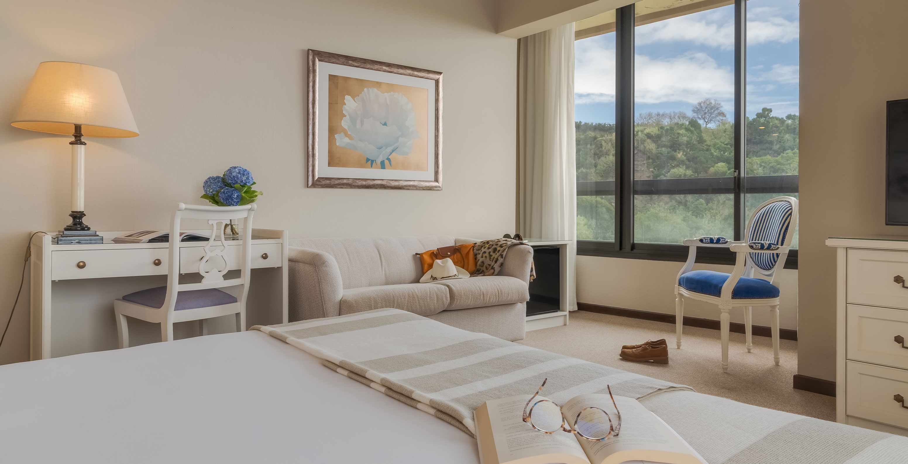 Das Standard Meerblick Zimmer im Pestana Bahia Praia hat einen Schreibtisch, ein Sofa und einen Stuhl am Fenster