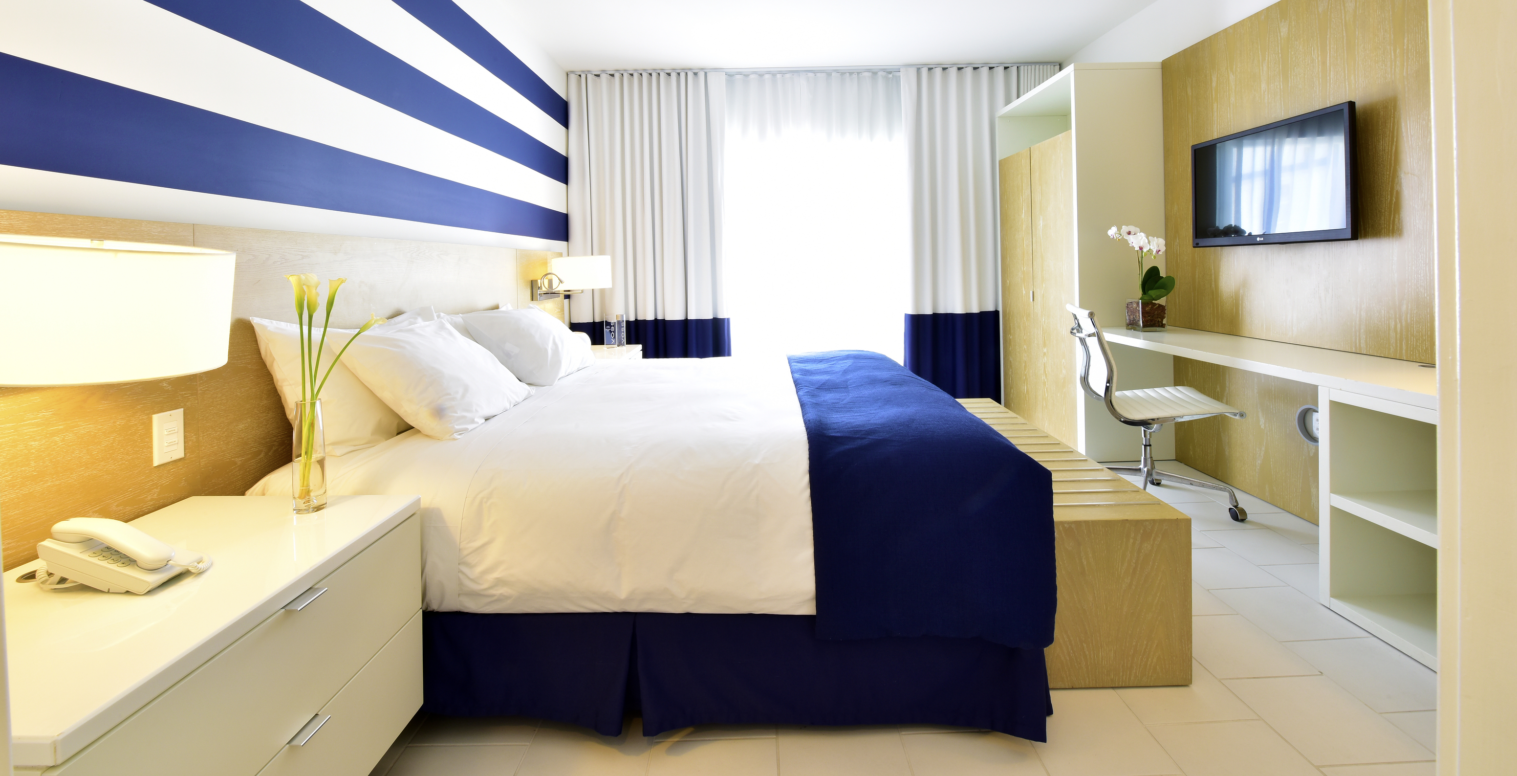 Die Master Suite im Pestana Miami South Beach hat Doppelbett, Kleiderschrank, Fernseher und Tisch