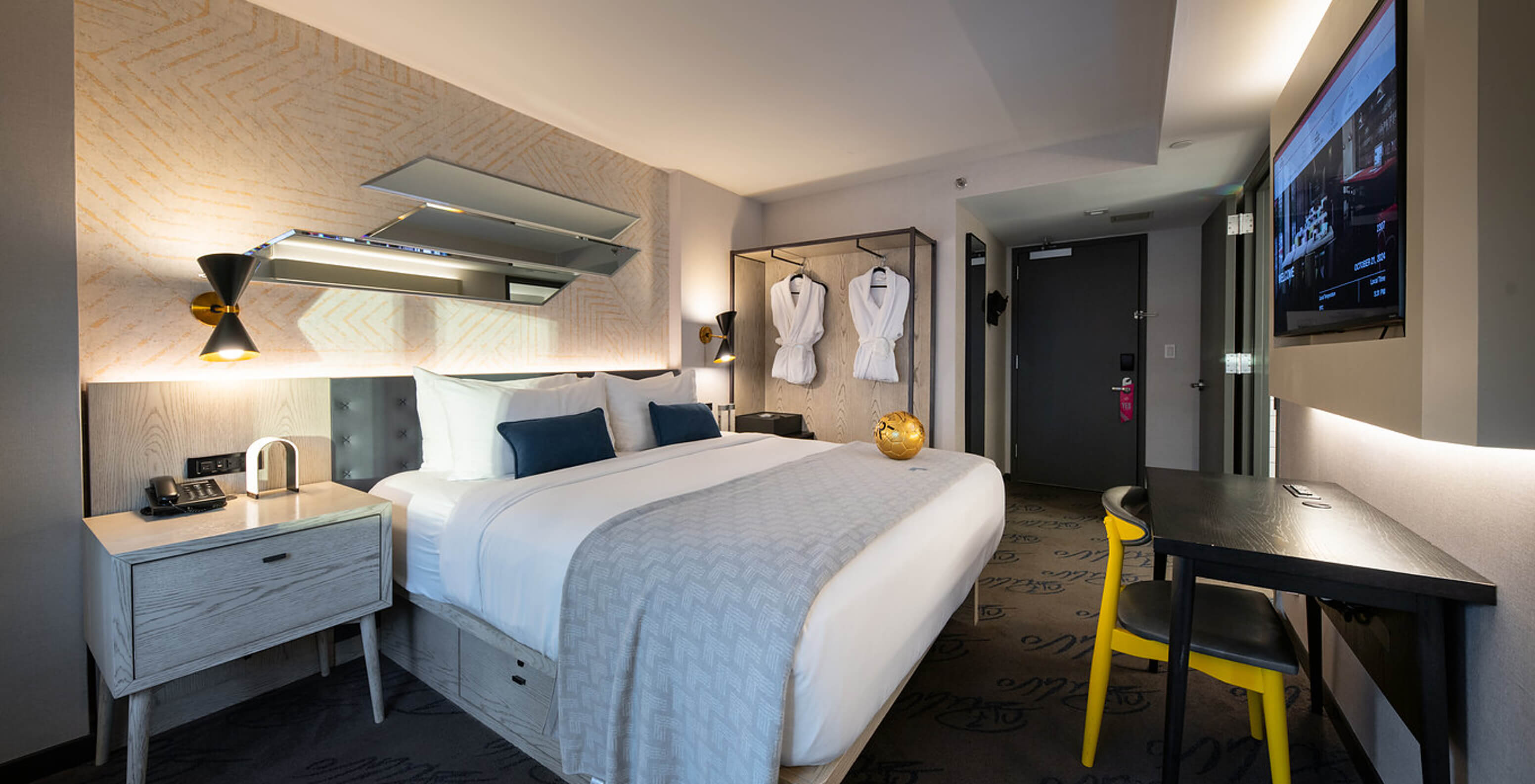 Das Deluxe King Room im Pestana CR7 Times Square hat ein Doppelbett, einen Schreibtisch und einen Fernseher