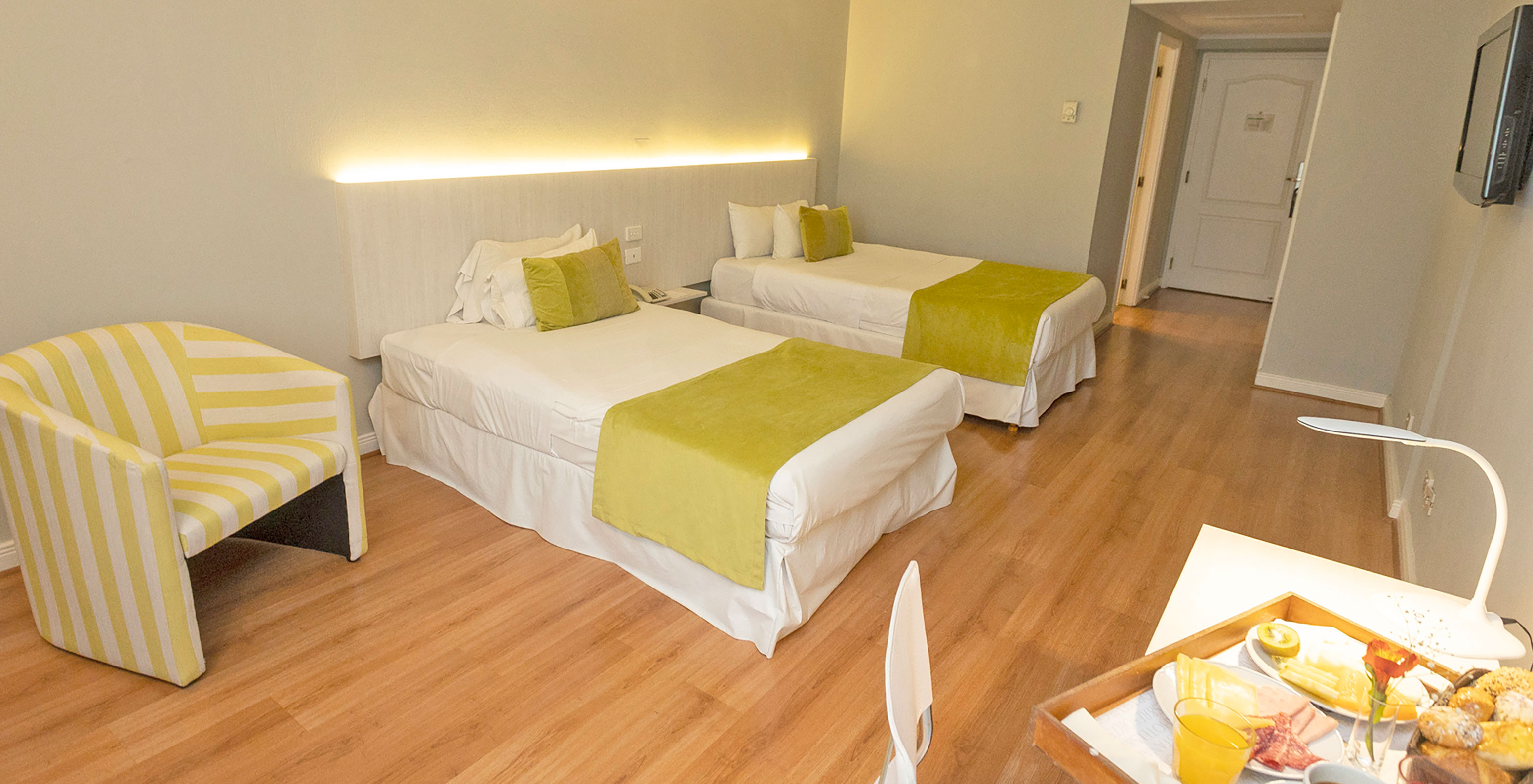 The Twin Superior Room at Pestana Buenos Aires has two single beds, a bedside table, a chair, and a TV