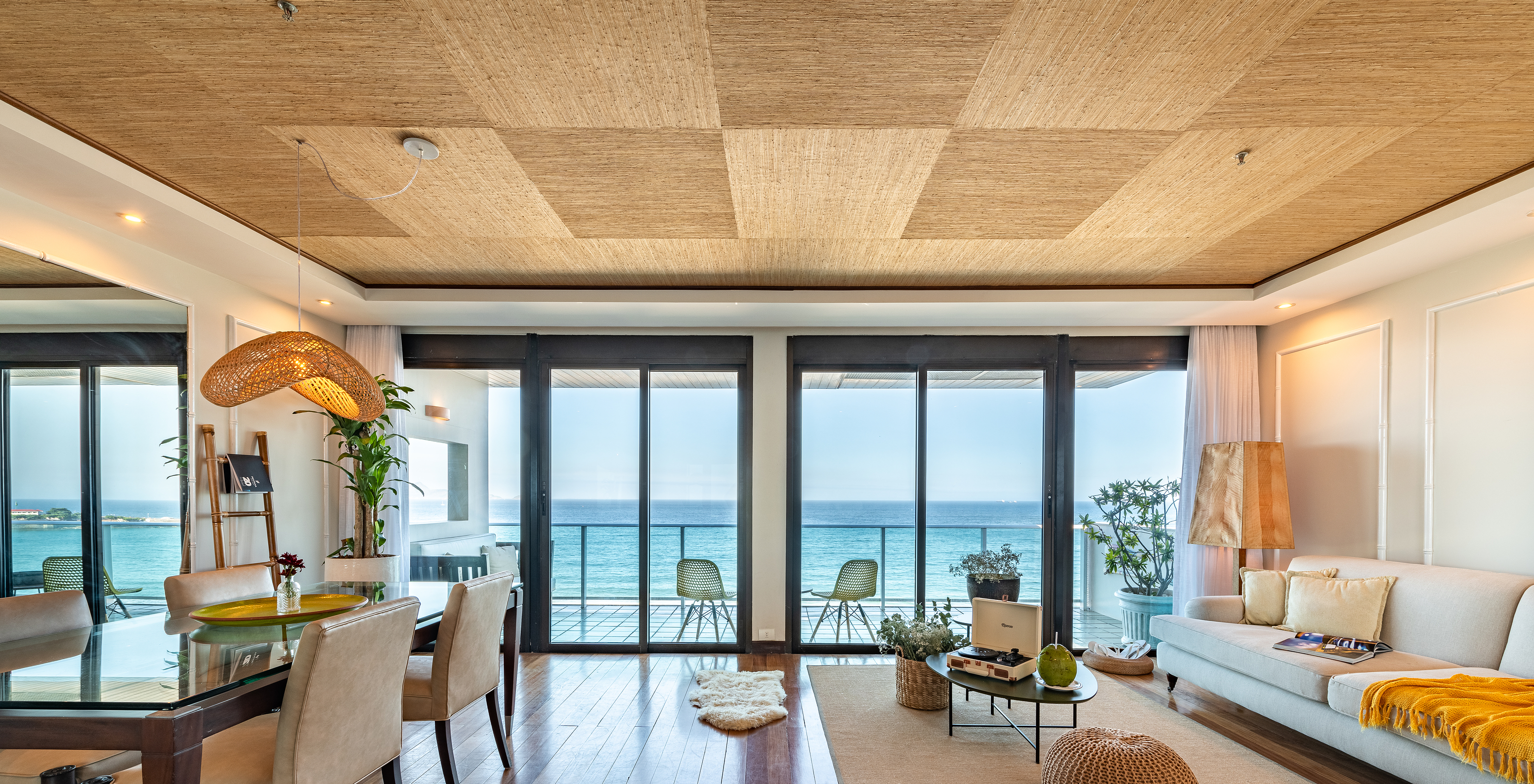 The Presidential Suite of Pestana Rio Atlântica has a living room with two large windows and a balcony with sea view