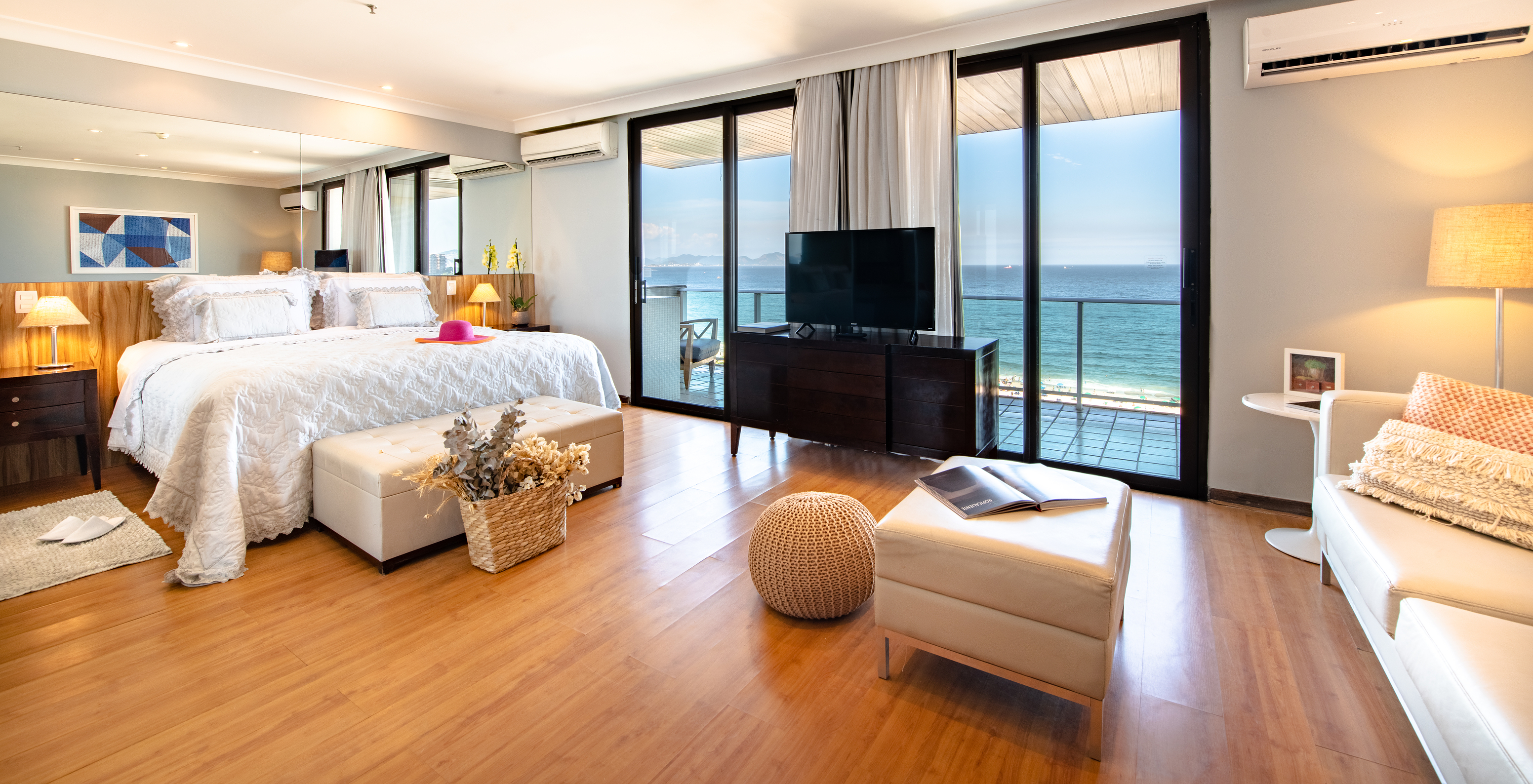 The Ocean Suite of Pestana Rio Atlântica has a double bed, television, and a balcony with a view of Copacabana Beach