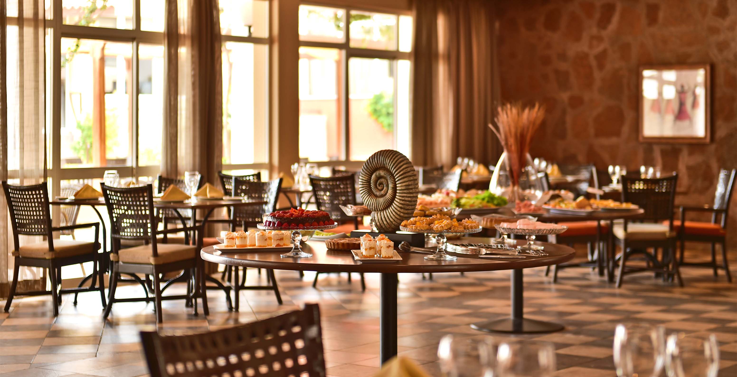 The Creole restaurant at the 4-Star Hotel in Cape Verde has a spacious area with chairs and offers a variety of dishes