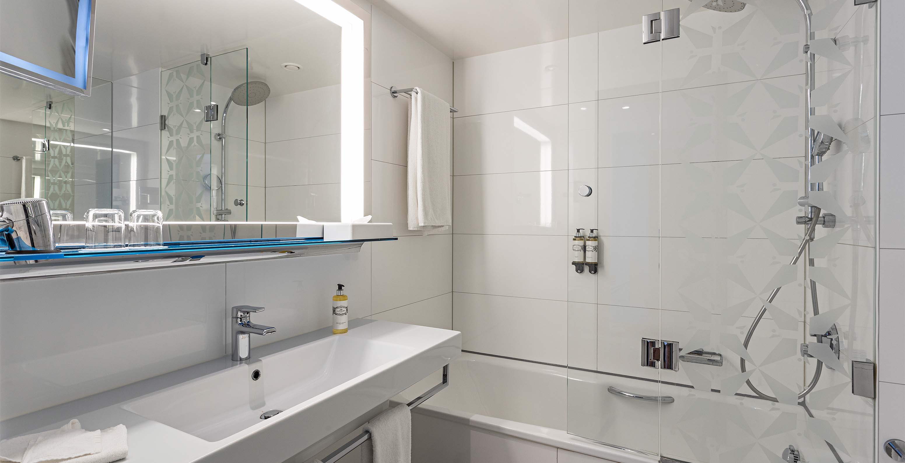 Premium Room with Panoramic Balcony at Pestana Berlin Tiergarten has a bathtub and shower, and sink with mirror