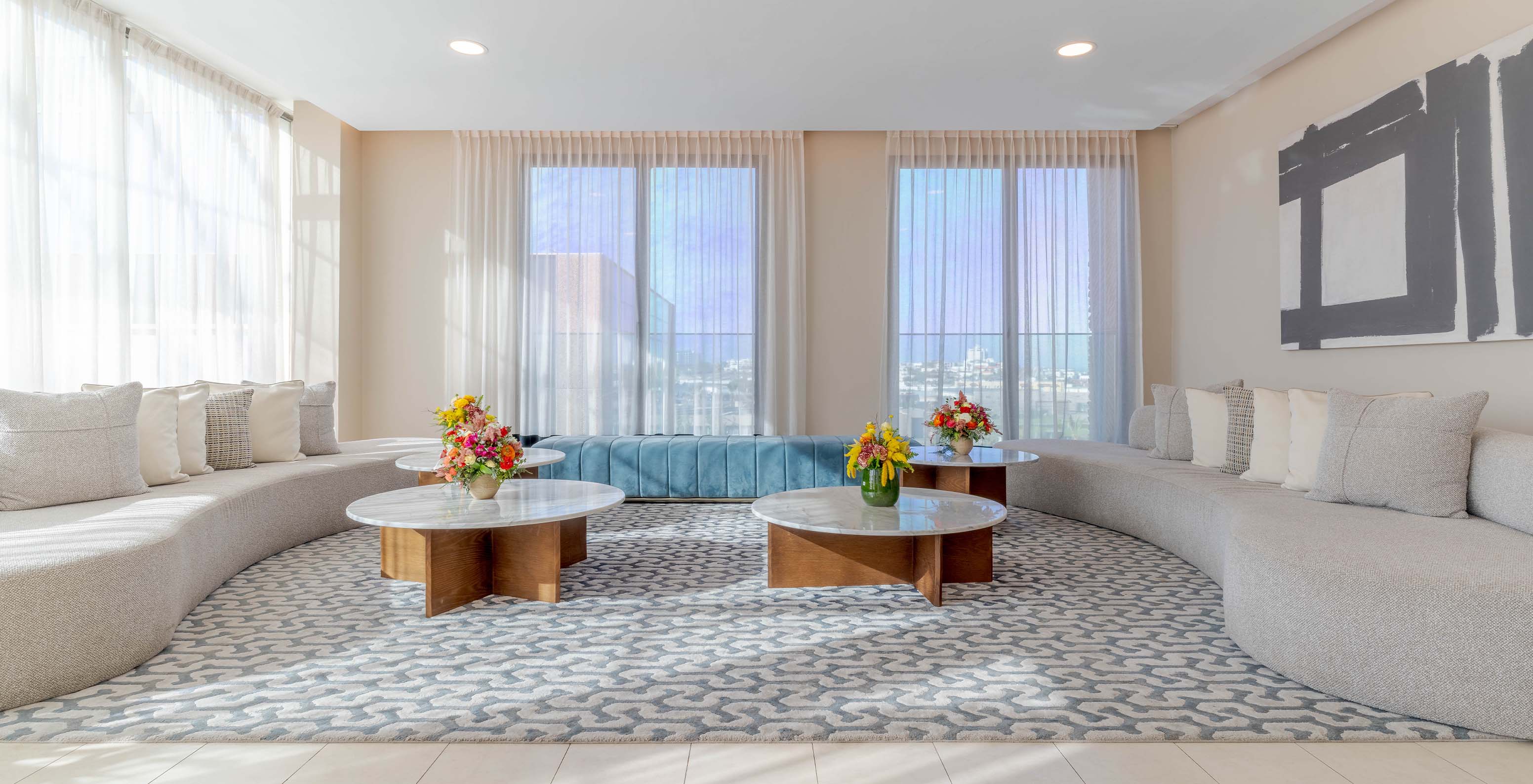 Lounge area in the hotel lobby with an amazing view of the beach with sea waves in the background