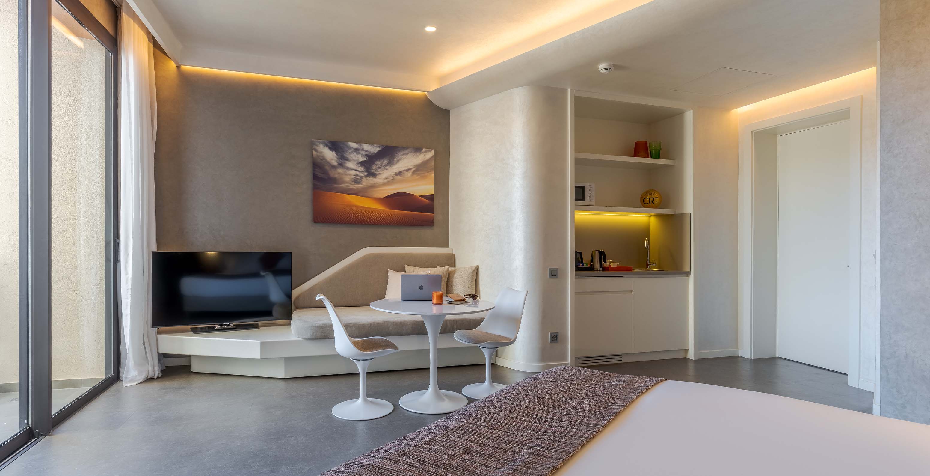 The CR7 Room Avenue at Pestana CR7 Marrakech has a TV, a sofa next to it, a sink, and a microwave