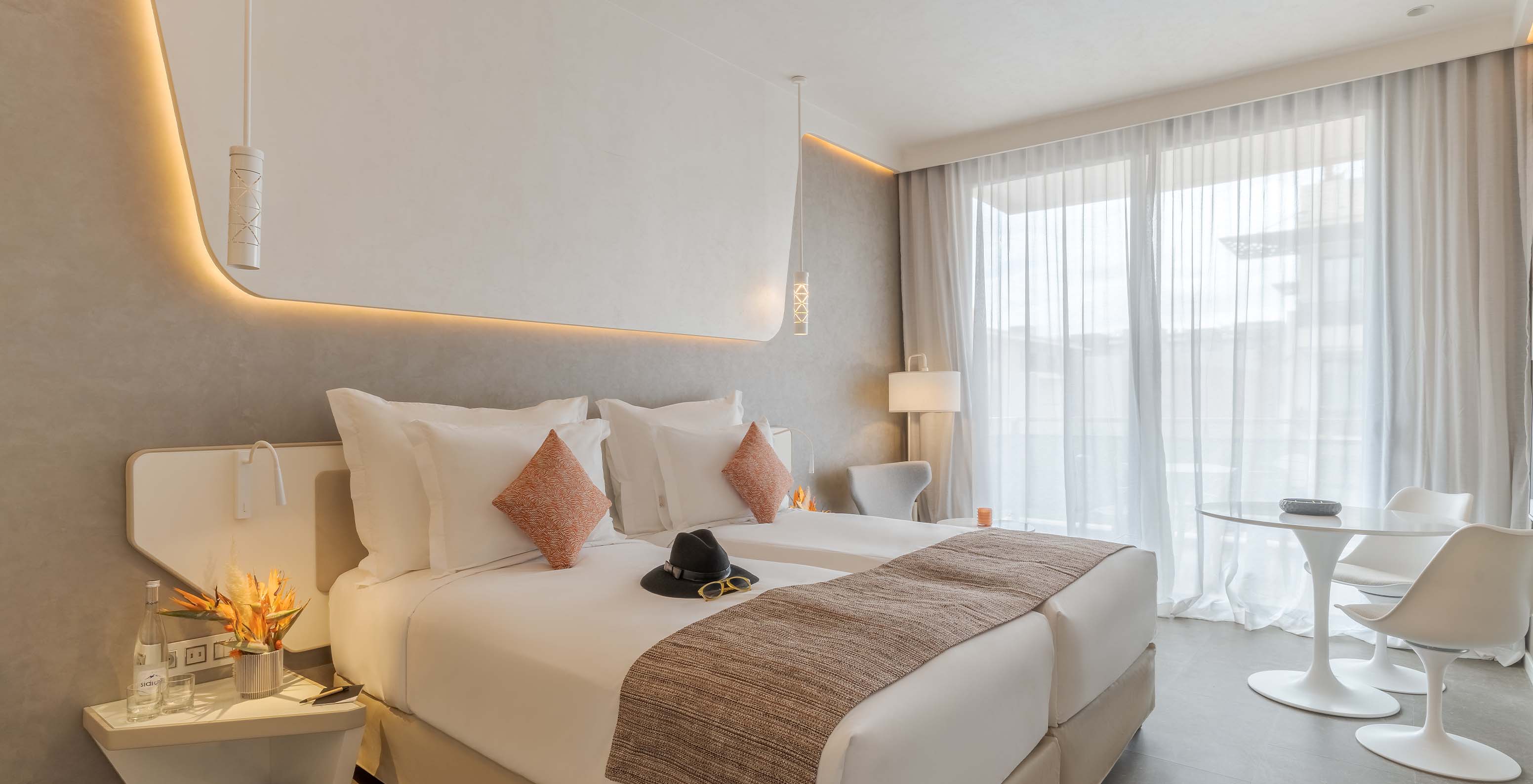 The CR7 Superior Avenue at Pestana CR7 Marrakech has a room with modern decor, wall lights, and two single beds