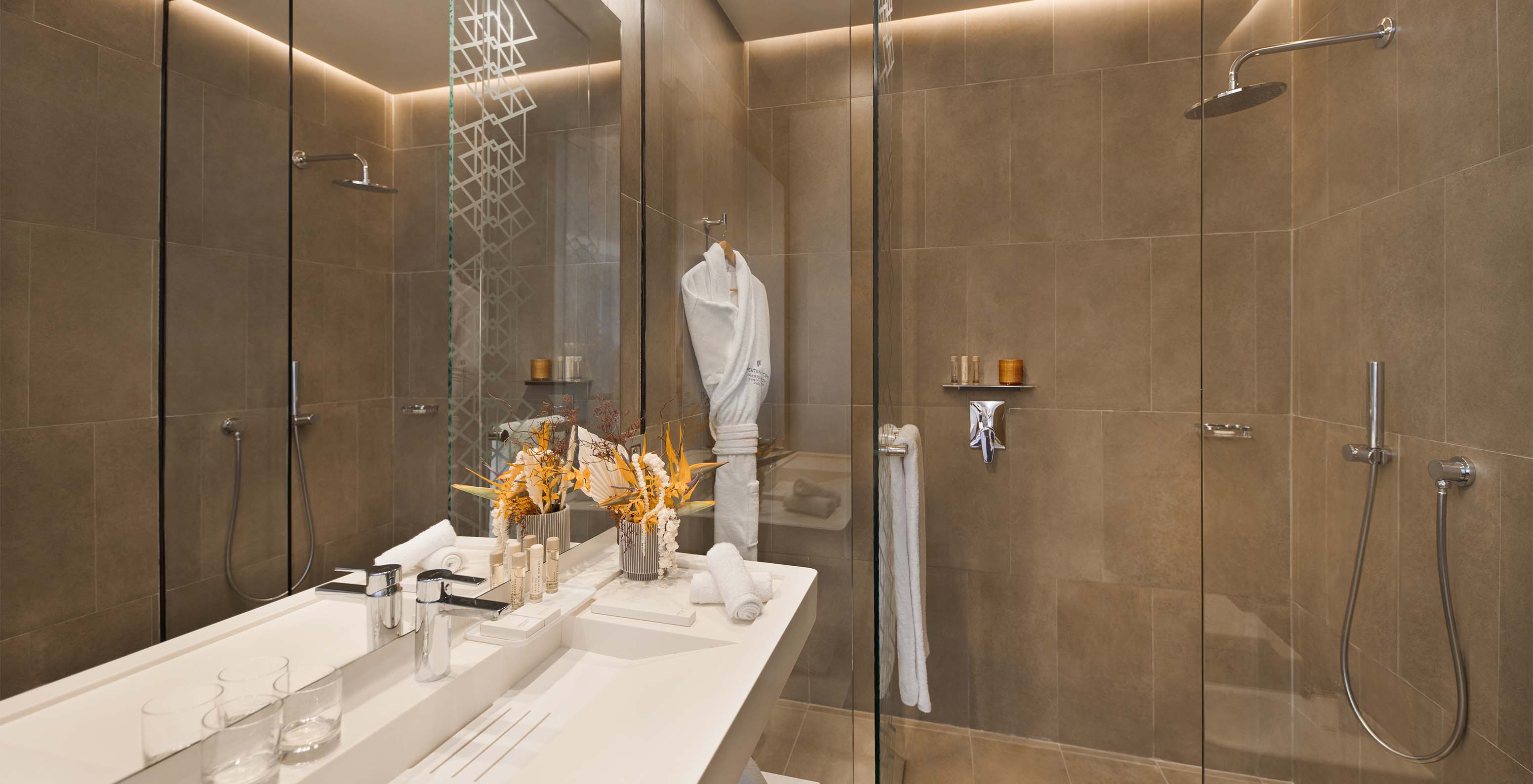 The CR7 Room Avenue at Pestana CR7 Marrakech has a bathroom with a walk-in shower, sink with mirror, and various amenities