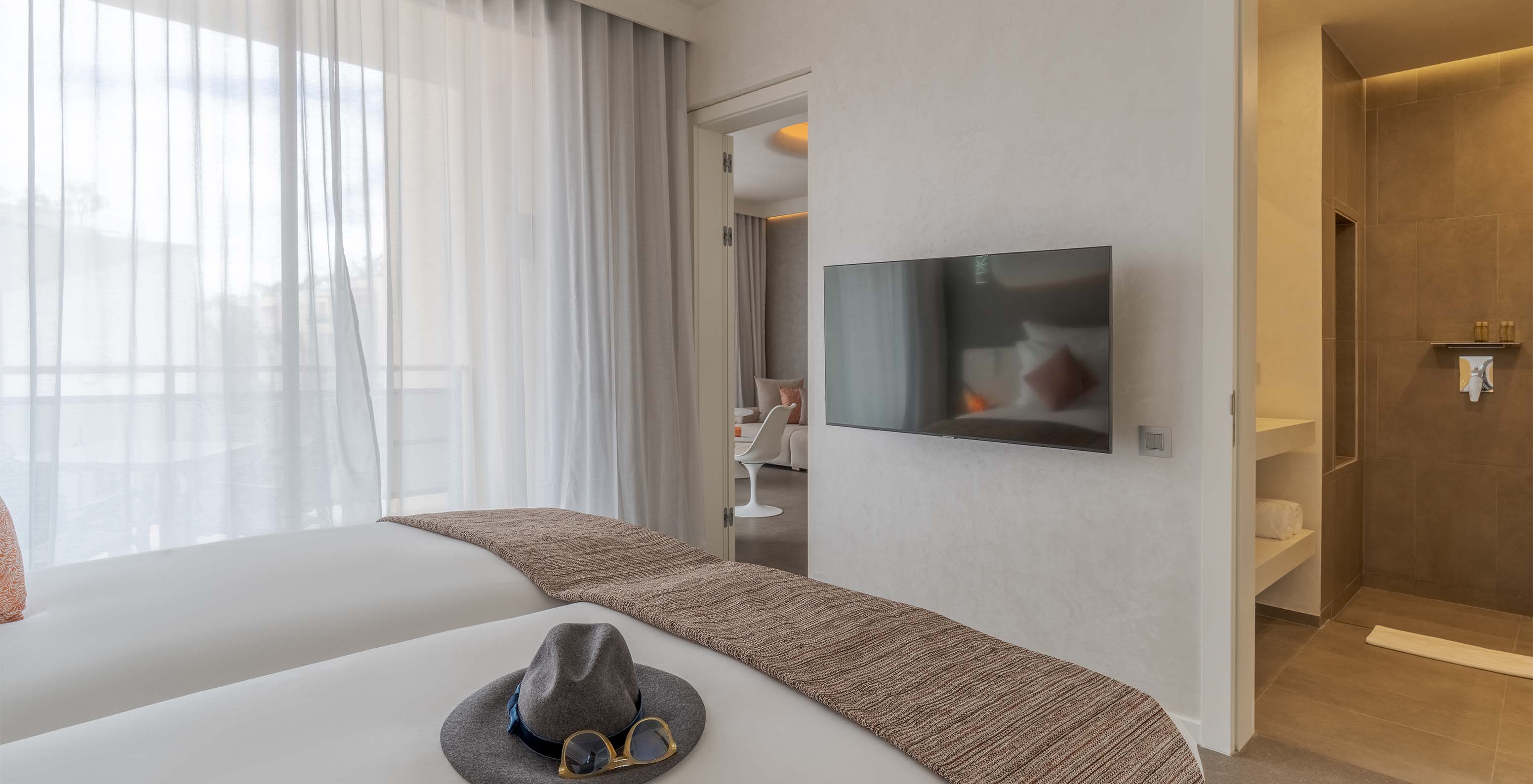 The CR7 Superior Avenue at Pestana CR7 Marrakech has two single beds and a TV in front, and a large window