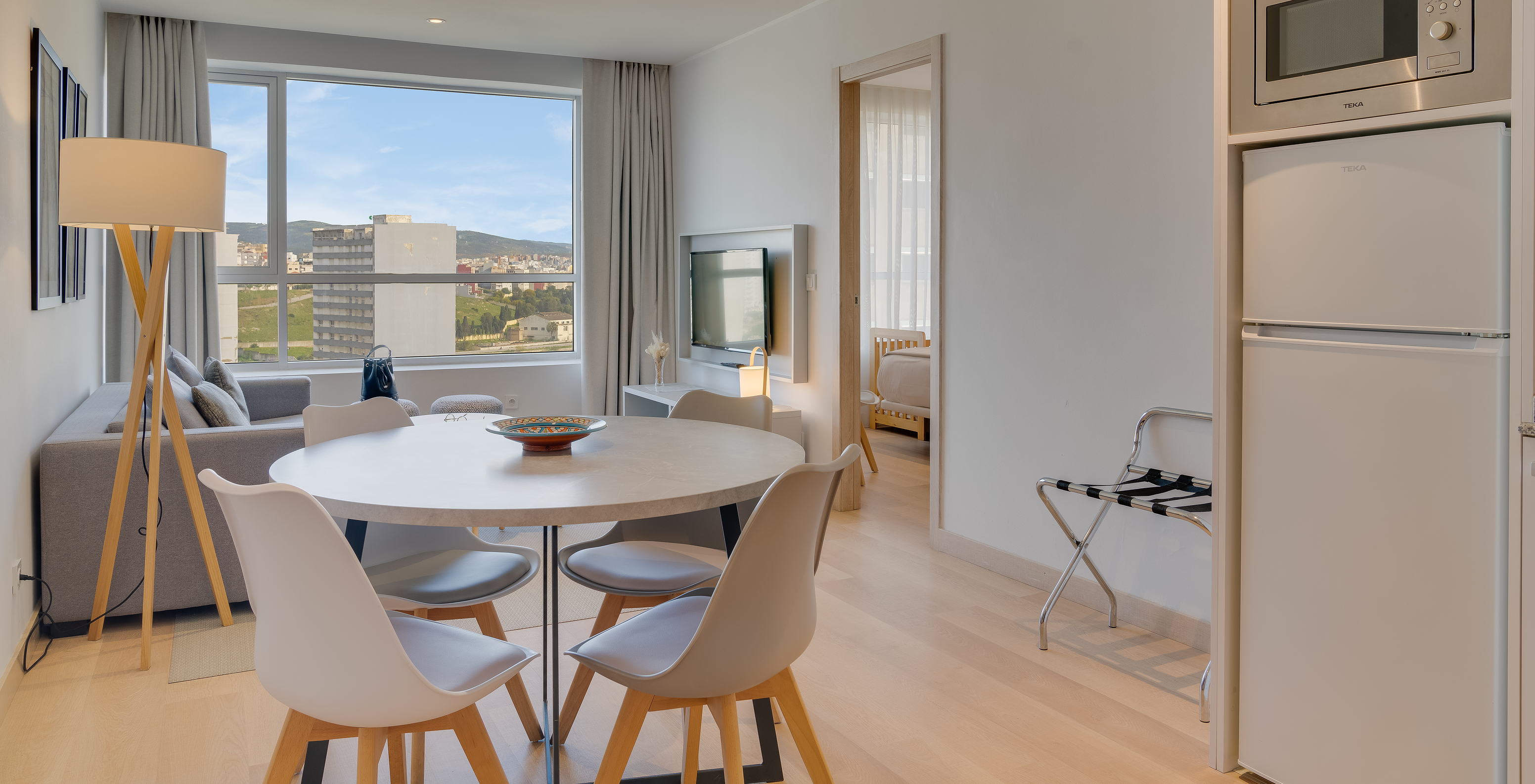 The Suite of Pestana Tanger City Center features a kitchen with refrigerator, microwave, and a dining table