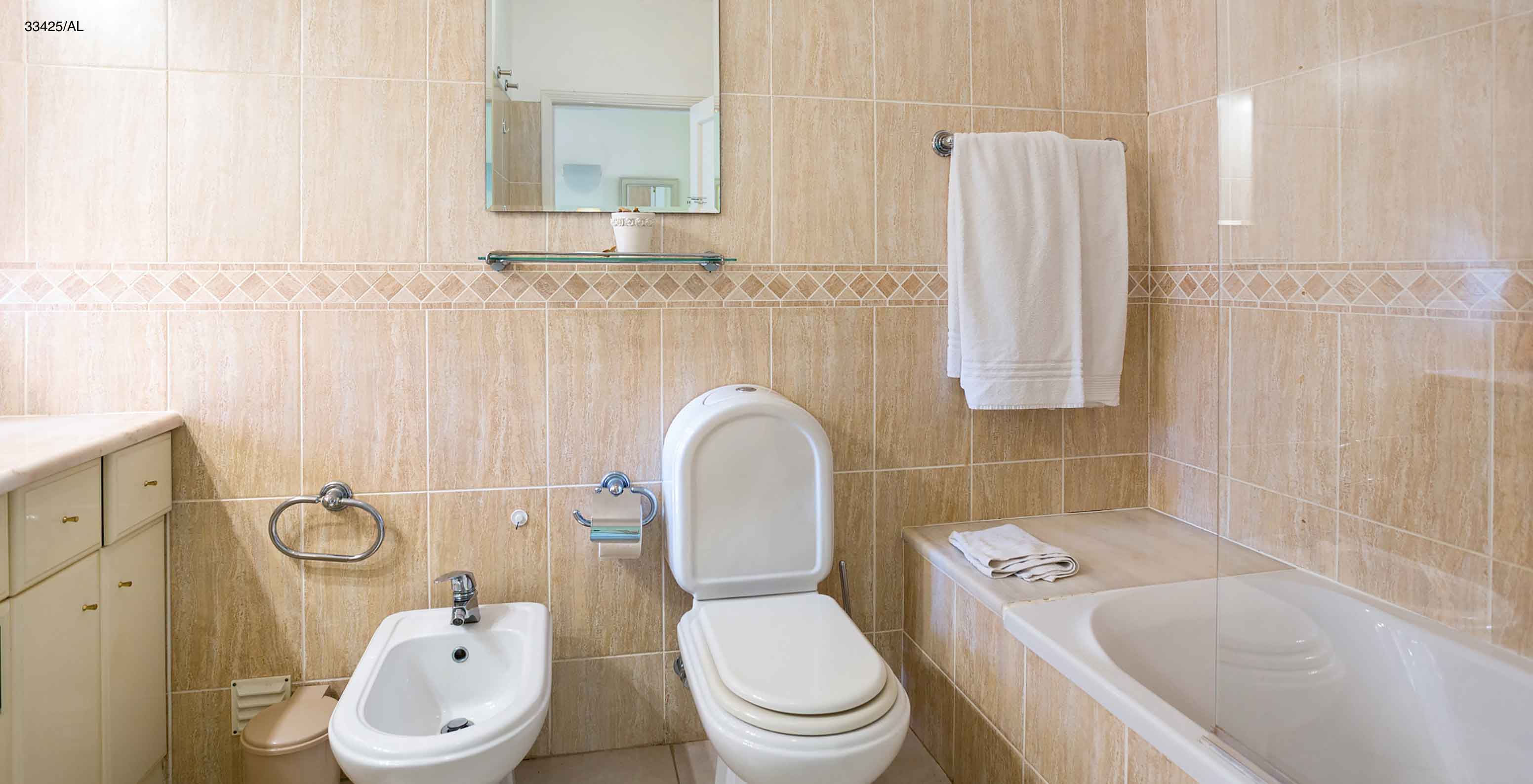 The Pestana Carvoeiro Golf T2 Standard Apartment has a bathroom with a bathtub, toilet, and bidet