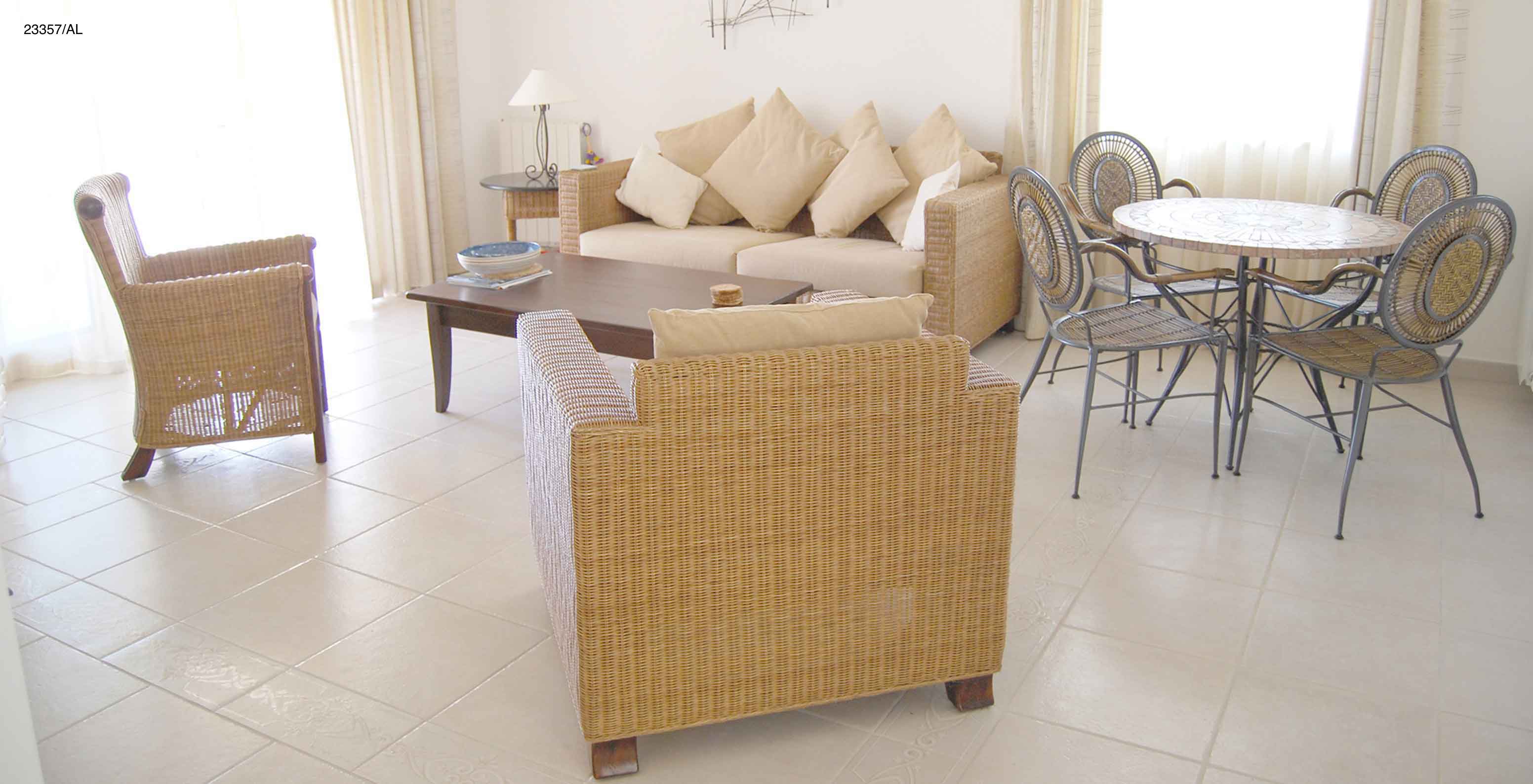 The Pestana Carvoeiro Golf T2 Standard Apartment has a living room with a sofa, armchairs, and dining table