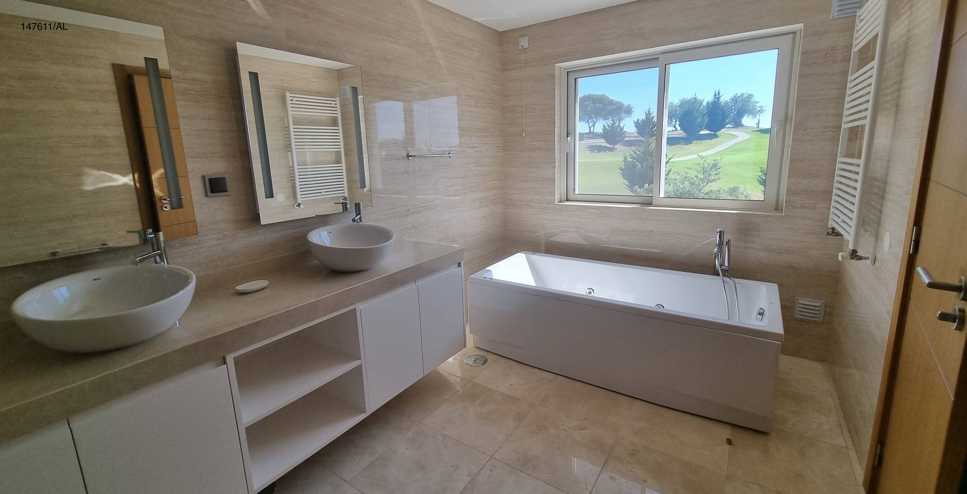 The Pestana Carvoeiro Golf V5 Standard Villa has a bathroom with two sinks, a bathtub, and a mirror