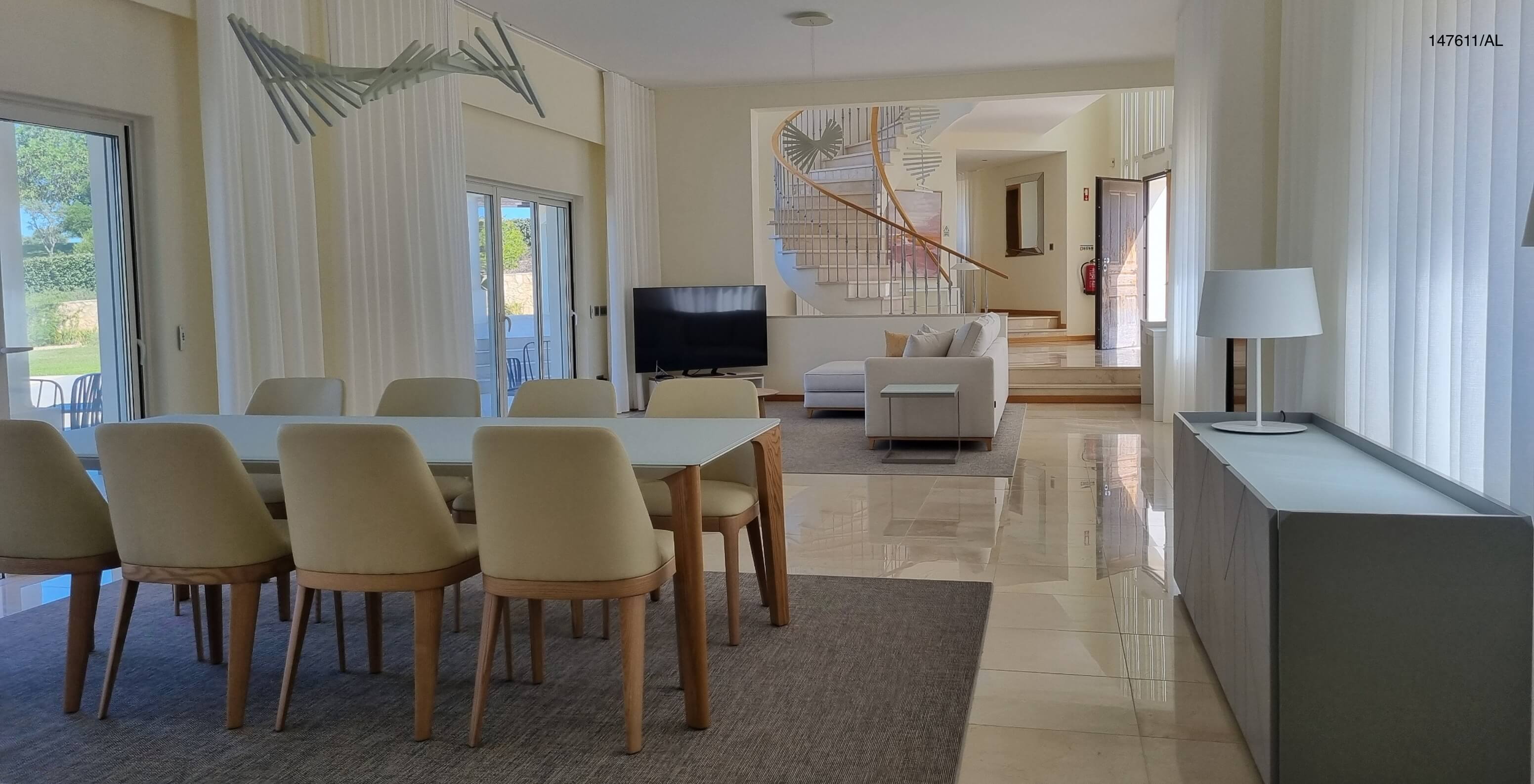 The Pestana Carvoeiro Golf V5 Standard Villa has a spacious living room with a dining table, chairs, and TV