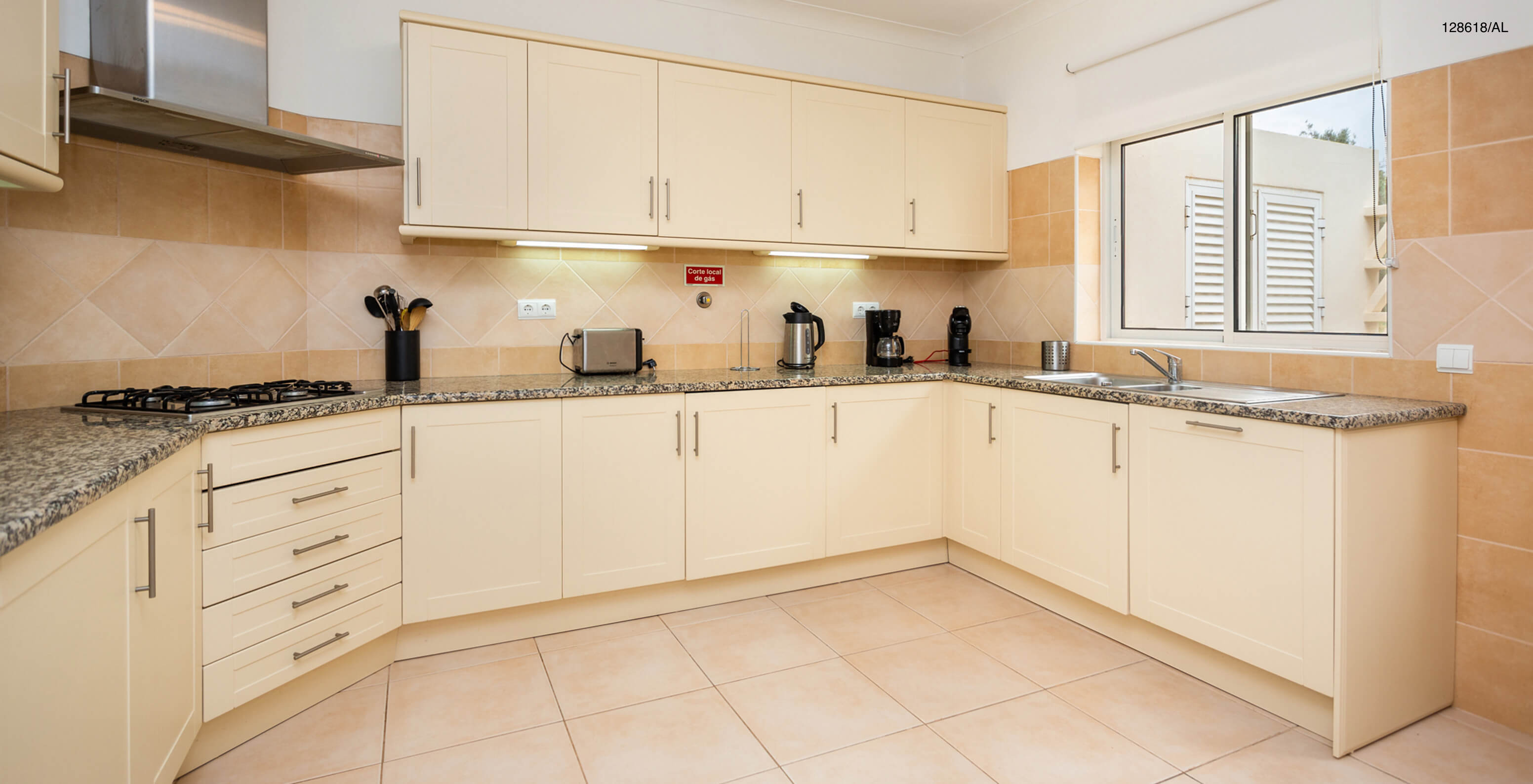 The Pestana Carvoeiro Golf V3 Superior Villa has a kitchen equipped with white cabinets and appliances