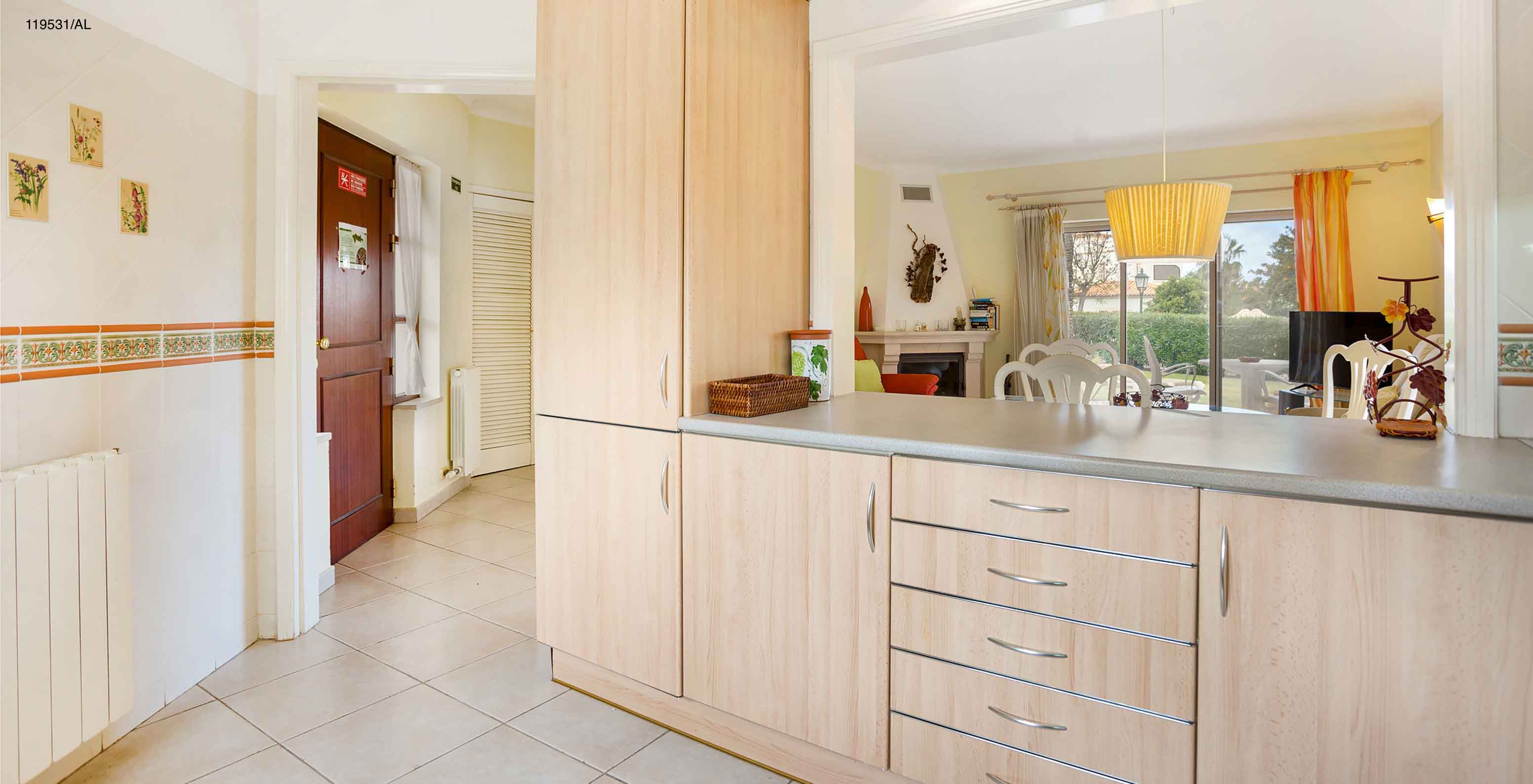 The Pestana Carvoeiro Golf T1 Standard Apartment has an entry to a kitchen with wooden cabinets