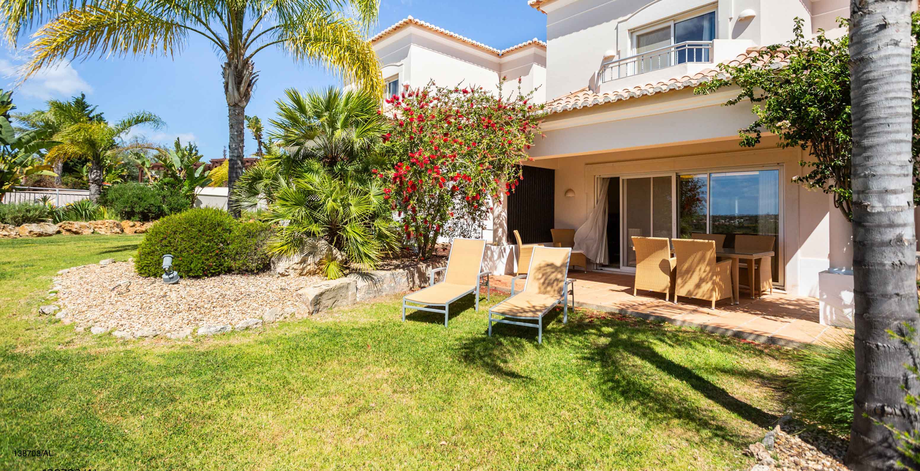 The Pestana Carvoeiro Golf T2 Superior Apartment has an exterior patio with grass and yellow loungers