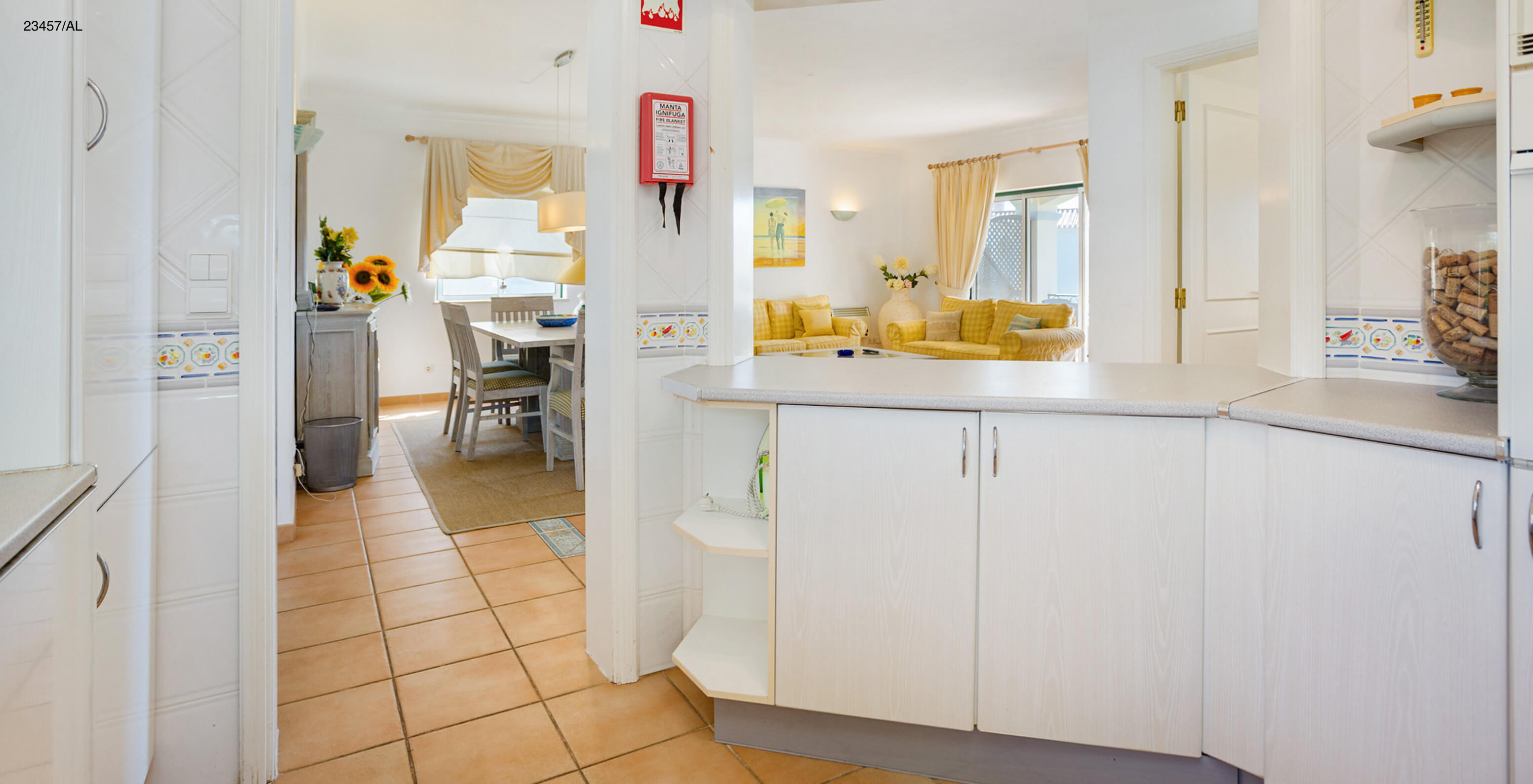 The Pestana Carvoeiro Golf T3 Standard Apartment has a kitchen with white cabinets and countertop open to the living room