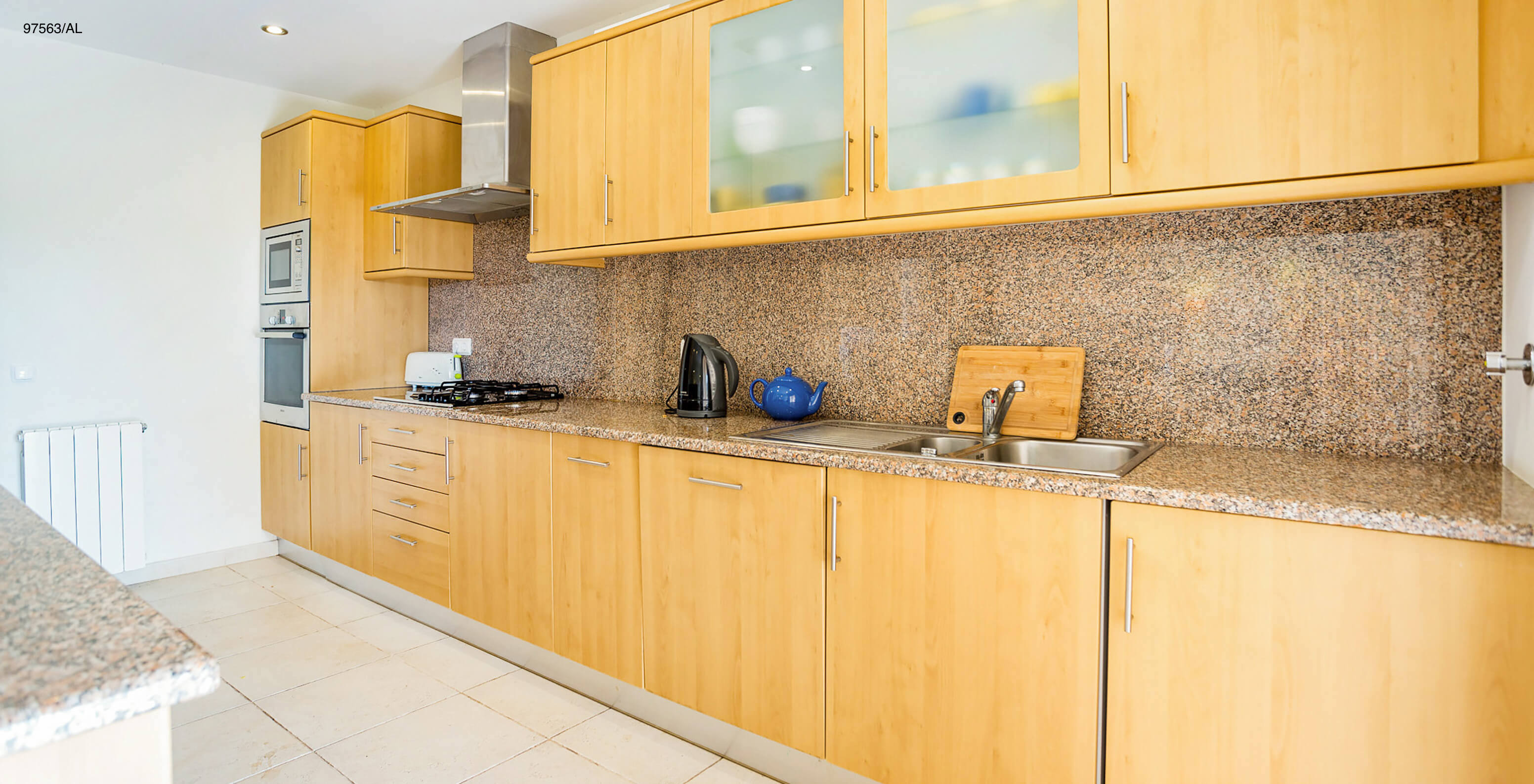 The Pestana Carvoeiro Golf T3 Superior Apartment has a kitchen with wooden cabinets and appliances