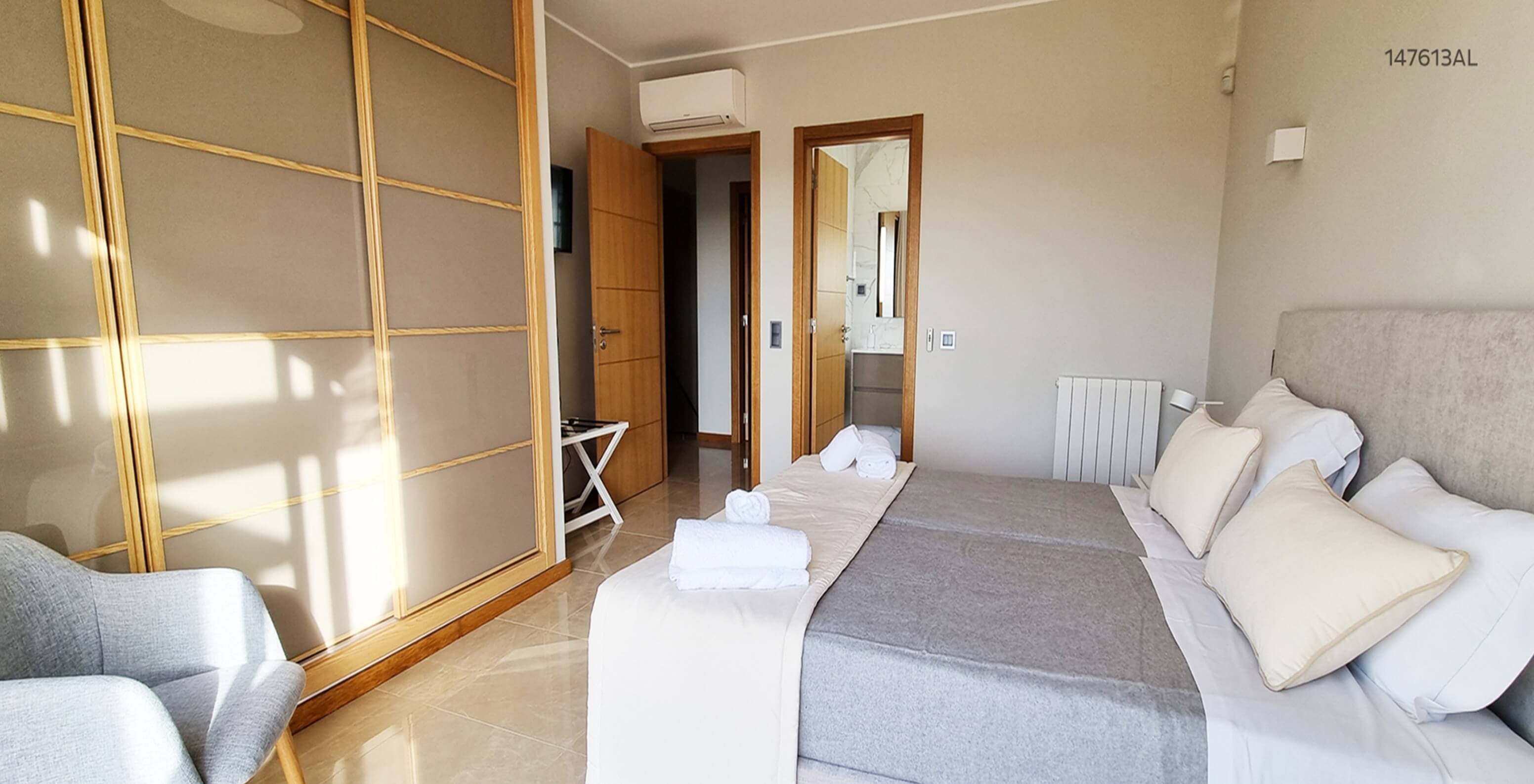 The Pestana Carvoeiro Golf V5 Standard Villa has a bedroom with two single beds, an armchair, and a nightstand