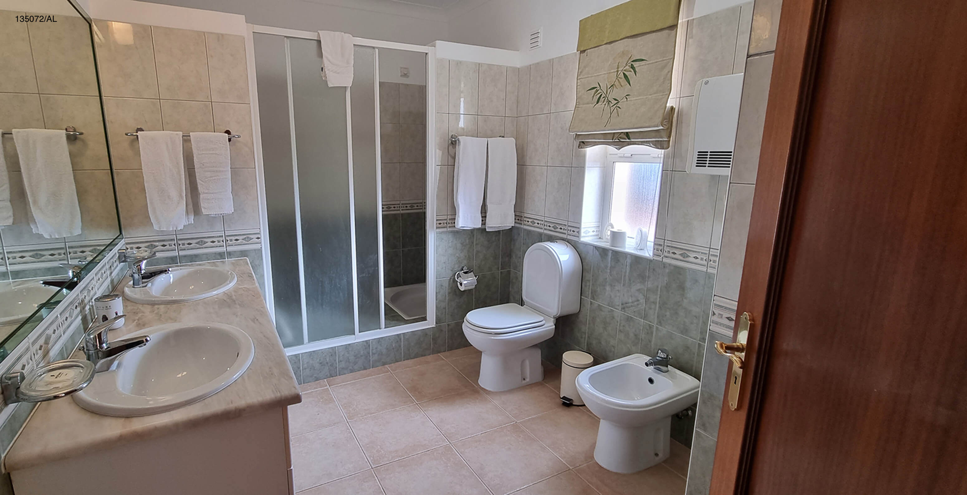 The Pestana Carvoeiro Golf V3 Standard Villa has a bathroom with a toilet, two sinks, and a shower