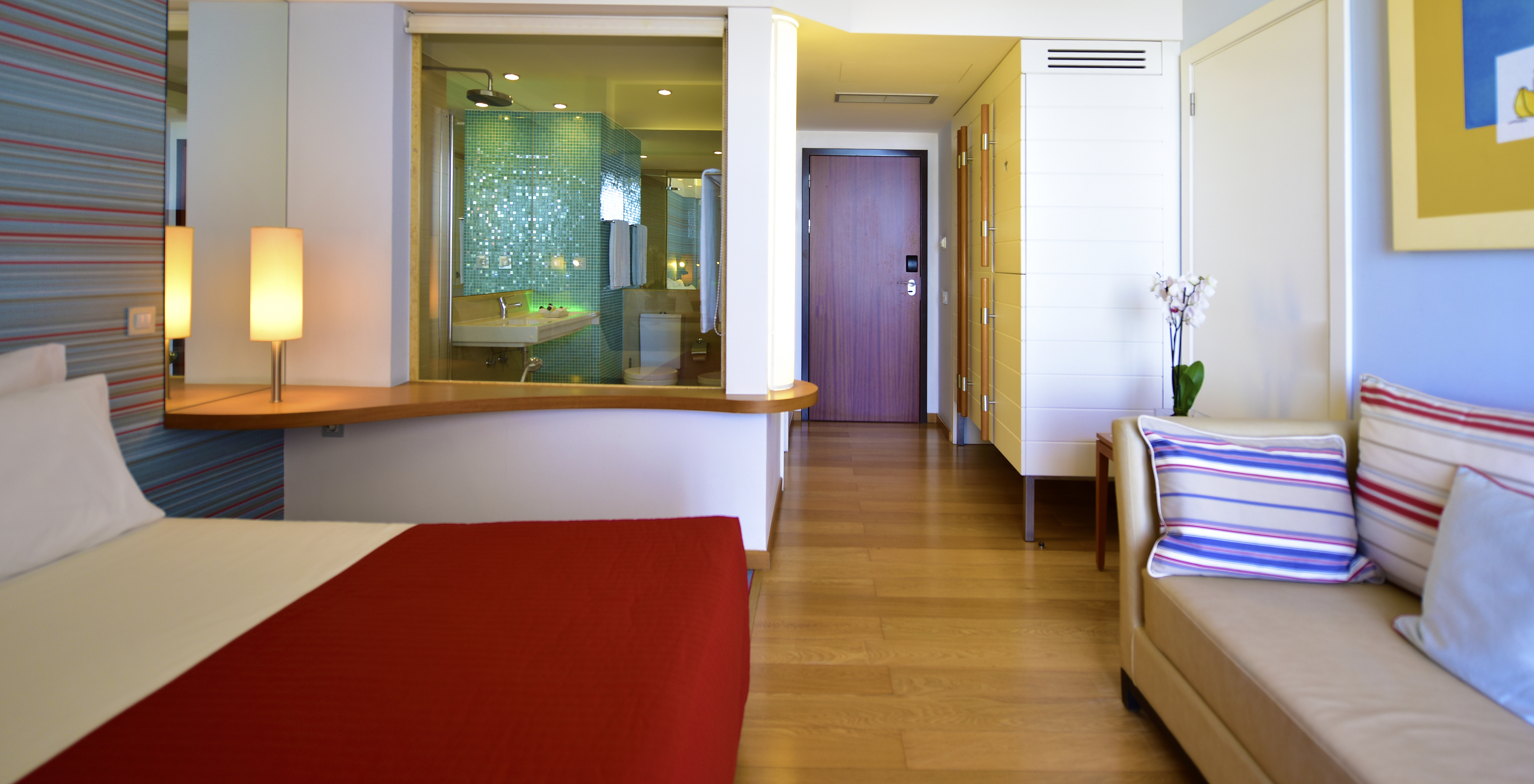 The Deluxe Garden View at Pestana Dom João II has a double bed, bedside table, and a wardrobe for clothes