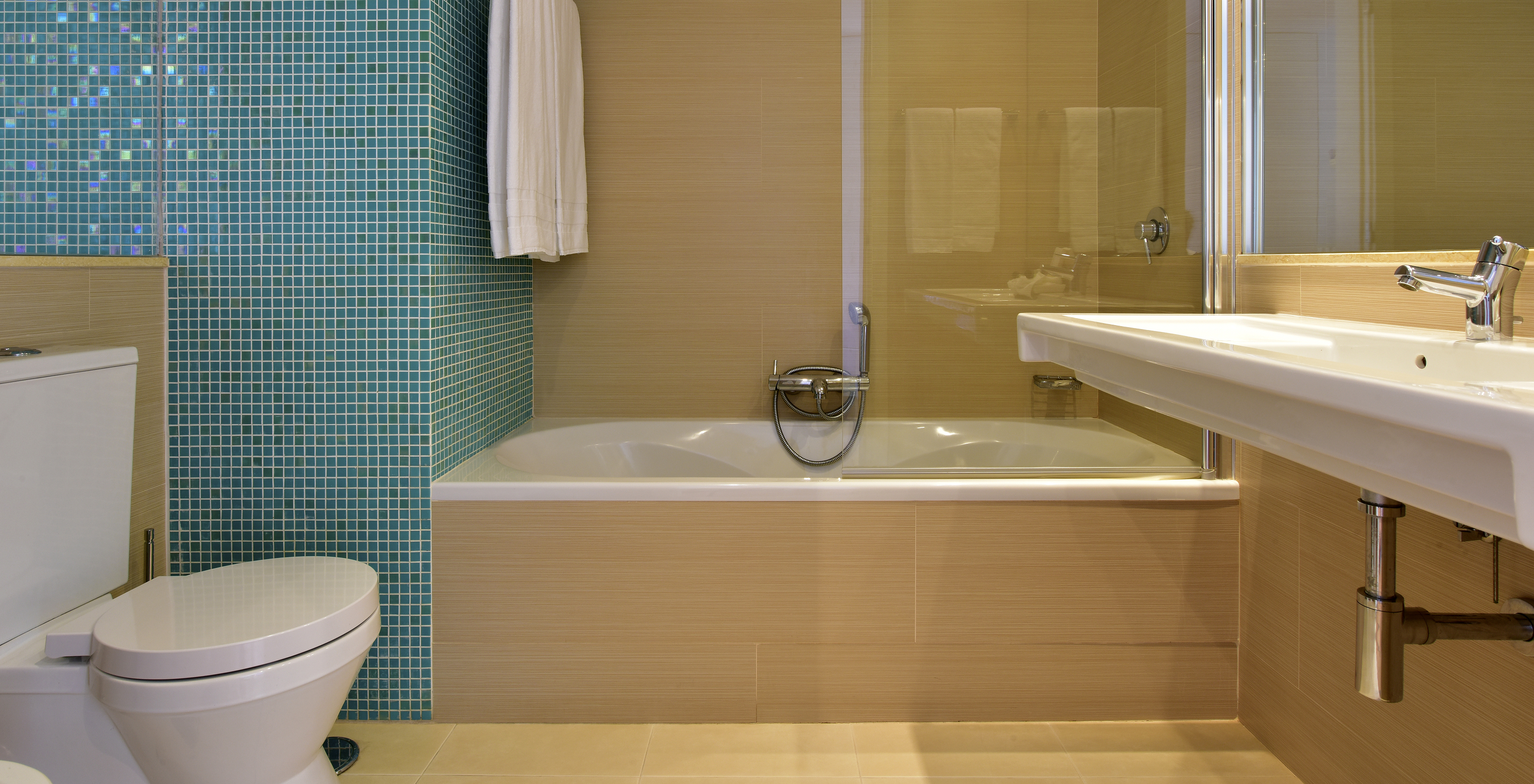 The Standard Suite at Pestana Dom João II includes a bathroom with a sink, mirror, and bathtub with shower