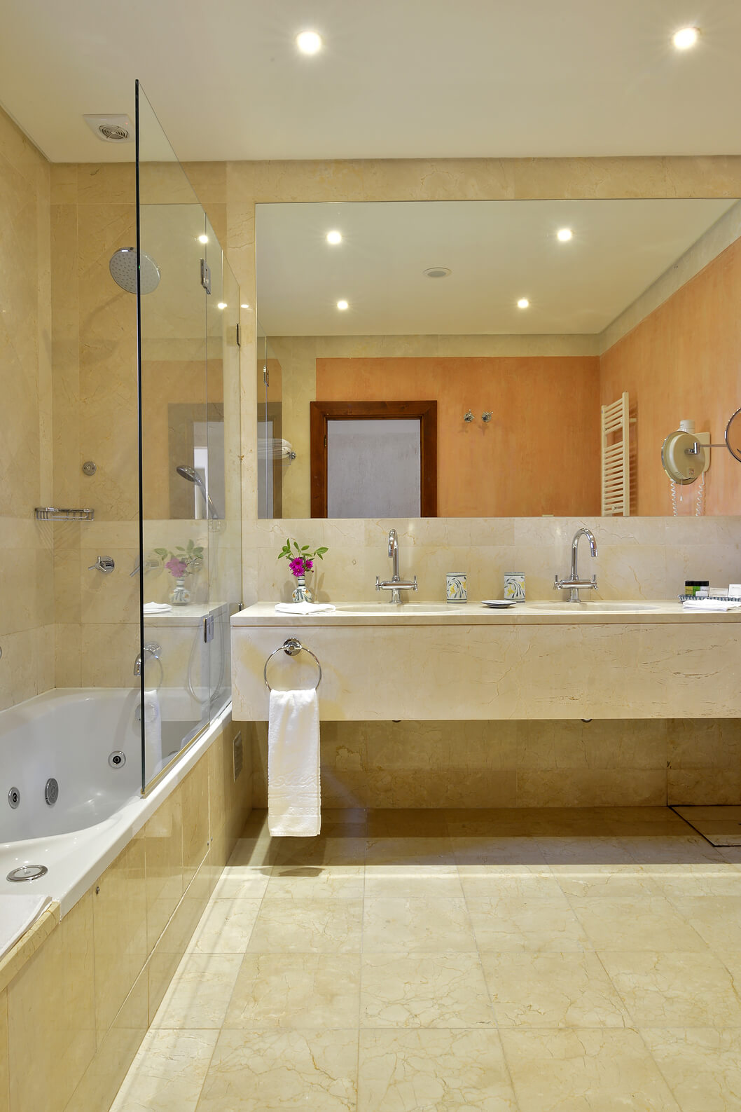 The Garden View Suite at Pestana Vila Sol - Vilamoura has a bathroom with a bathtub, two sinks, and a mirror