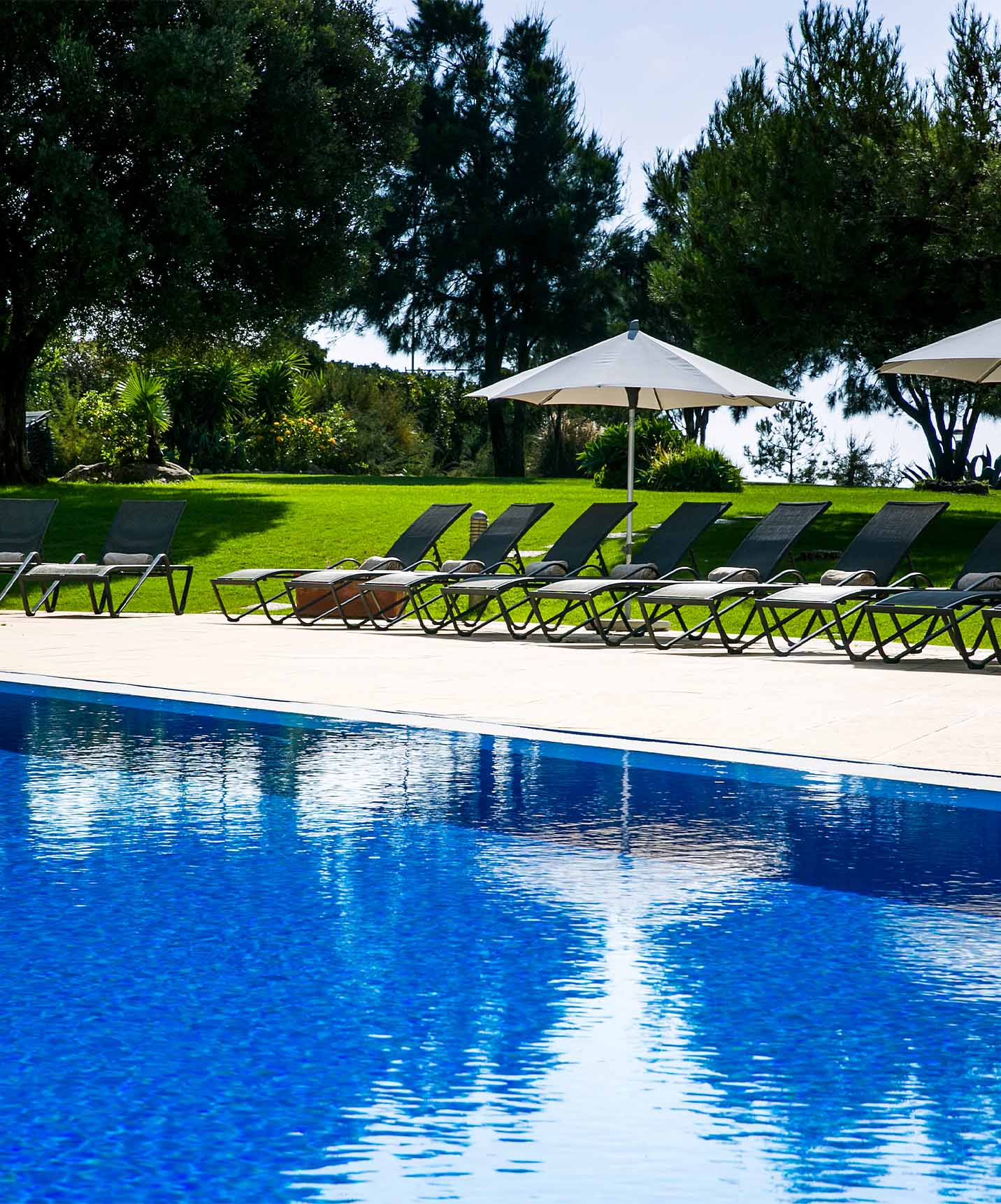 Pestana Cascais hotel by the sea with spa has an outdoor pool and loungers with umbrellas