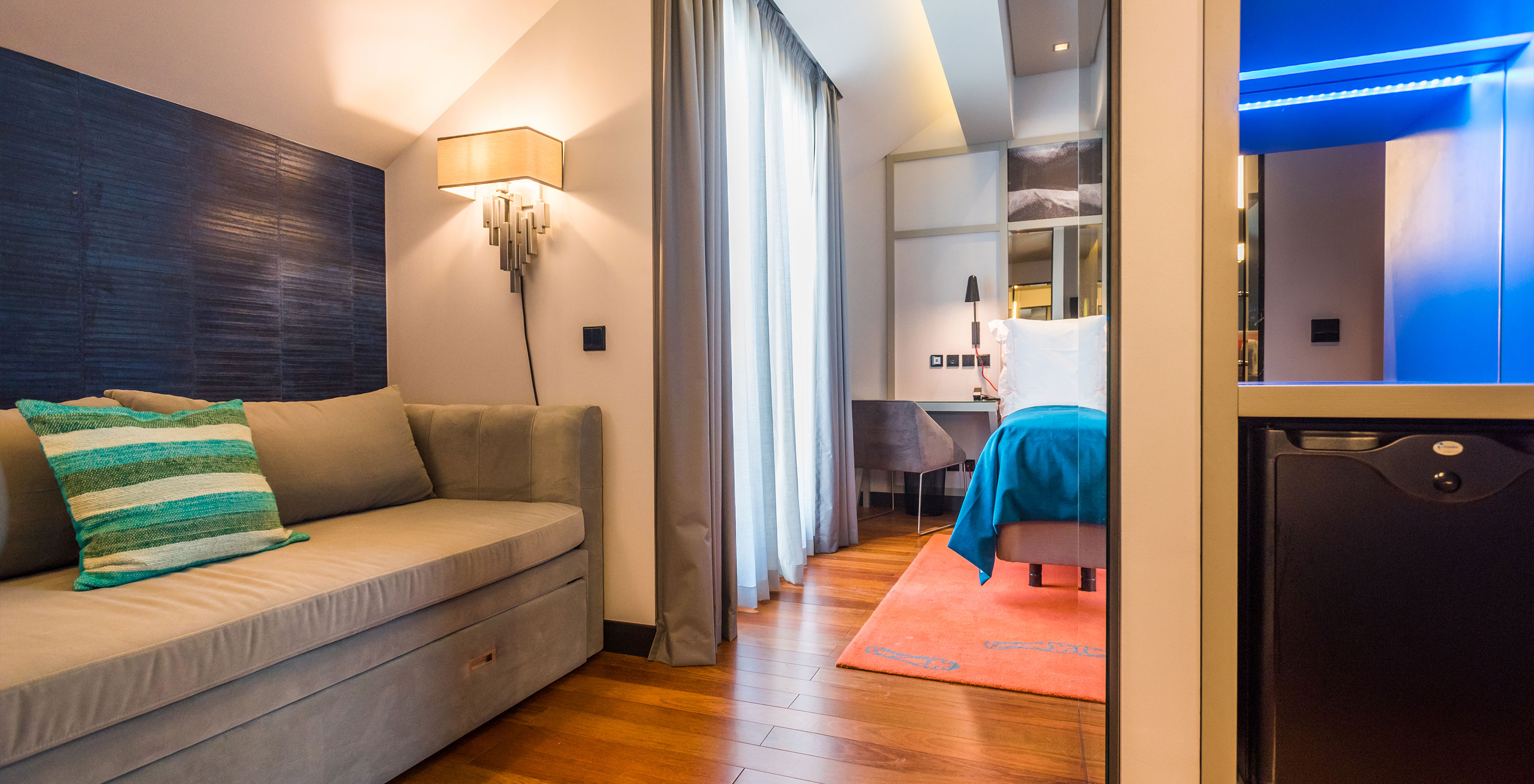 The CR7 Superior Rooftop Room at Pestana CR7 Lisboa includes a desk, sofa, and double bed