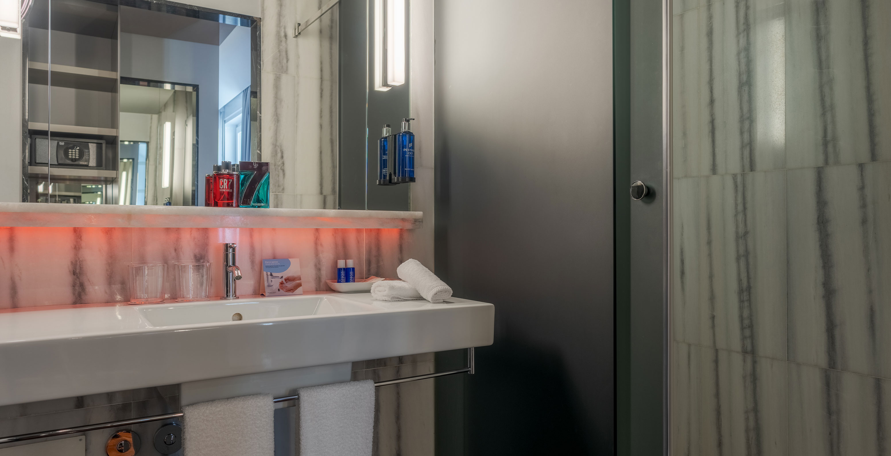 The CR7 Superior Rooftop Room at Pestana CR7 Lisboa has a bathroom with mirror, sink, and shower