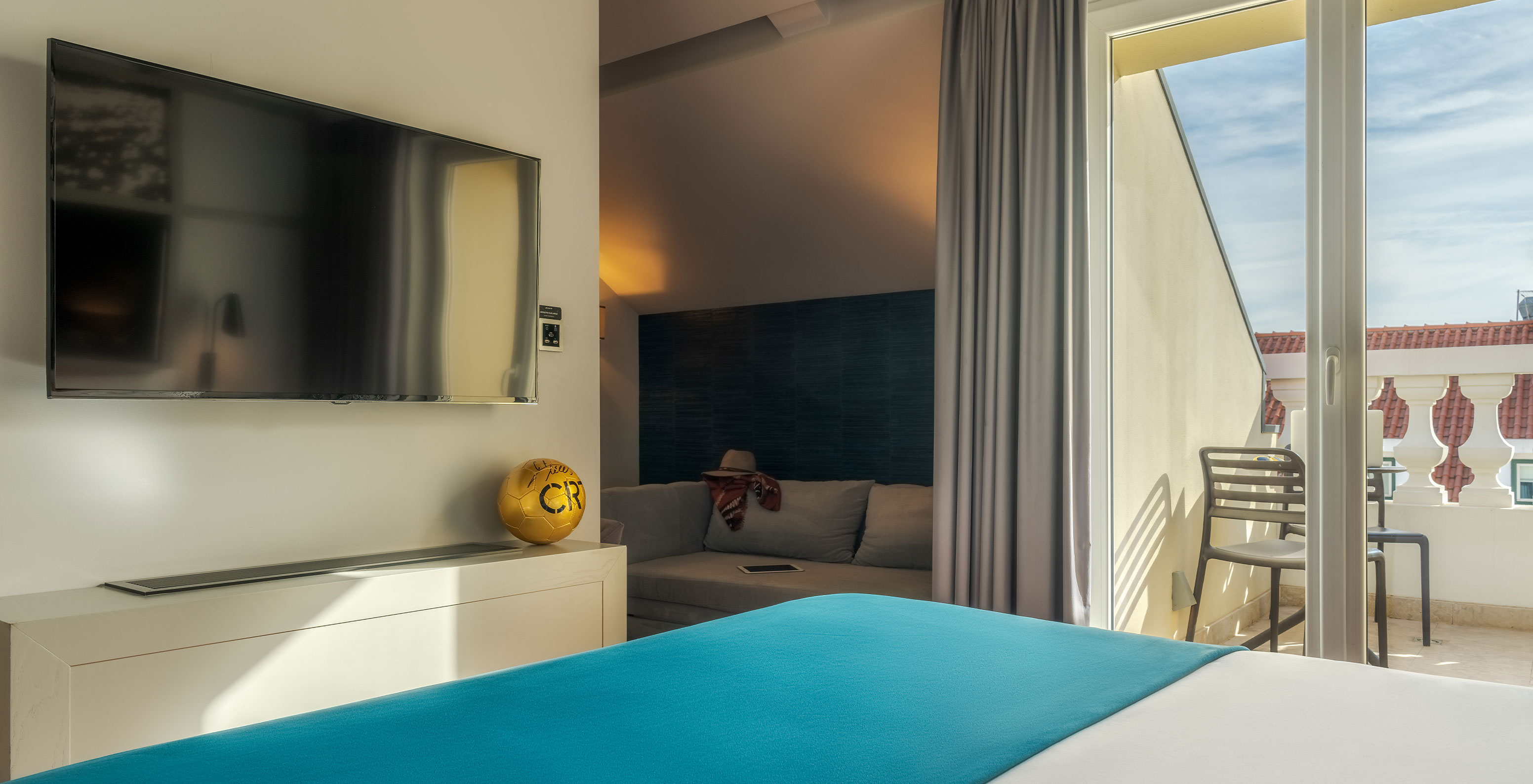 The CR7 Superior Rooftop Room at Pestana CR7 Lisboa has a double bed, sofa, and a CR7 football