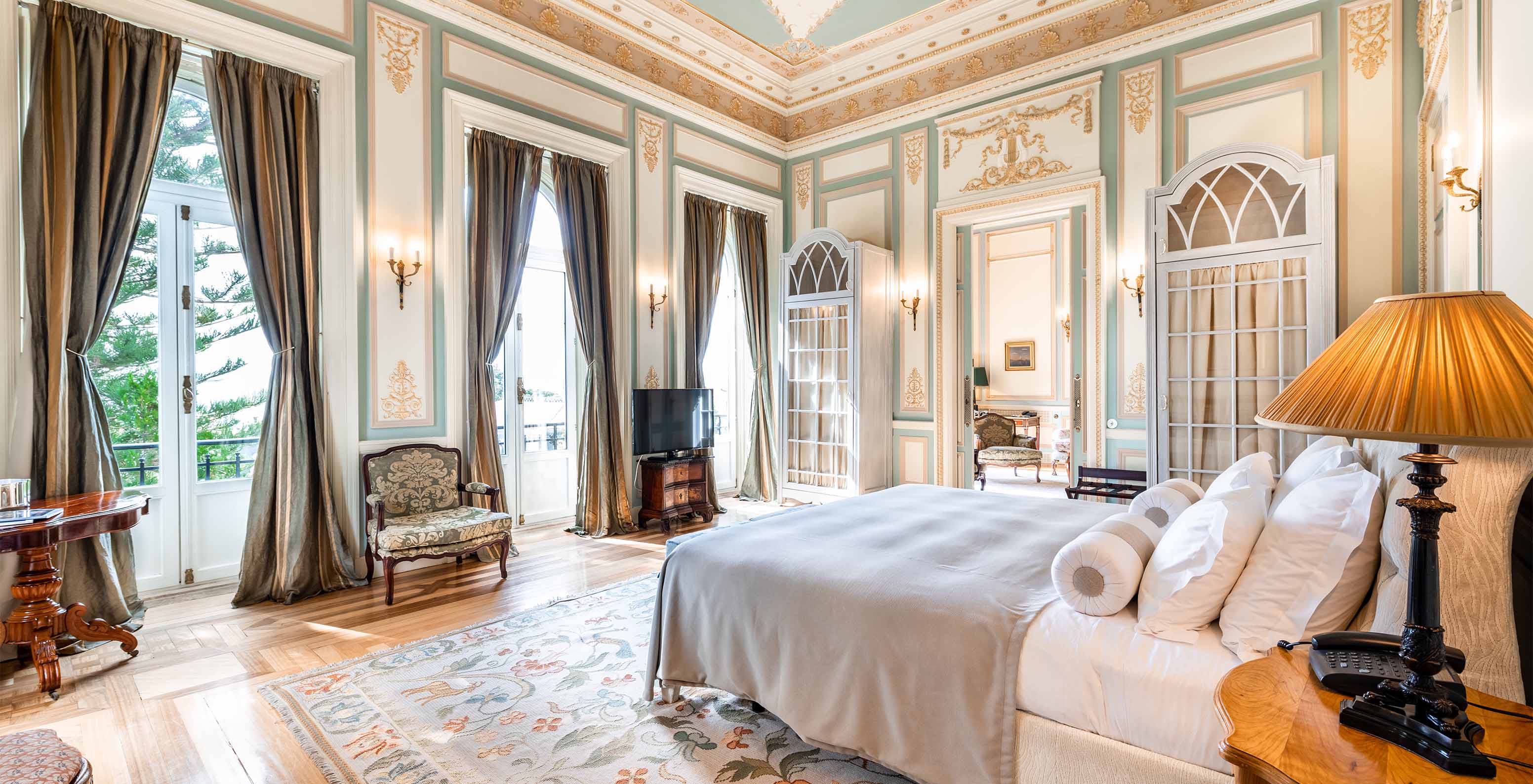 The Suite D. Manuel/D. Luís Filipe do Pestana Palace Lisboa has a large room with three windows overlooking the garden