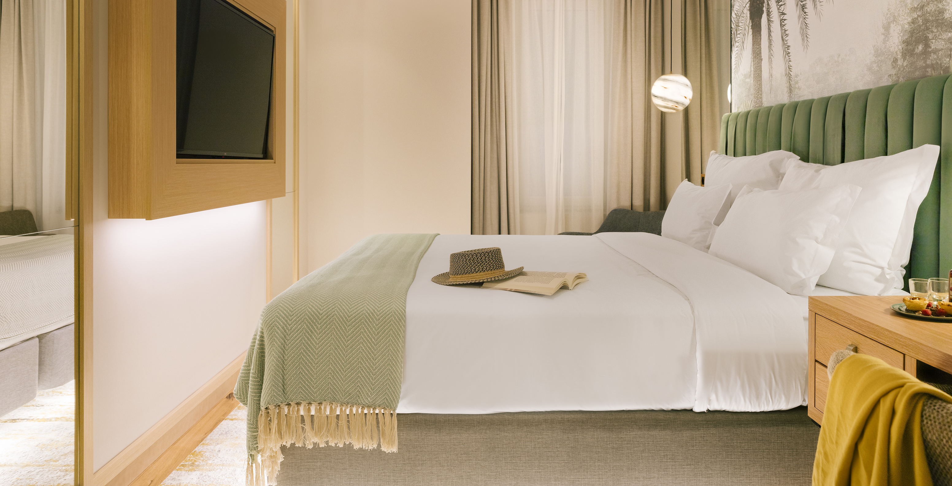 The Comfort Interior of Pestana Rua Augusta Lisboa has a double bed with television in front and a window with curtains