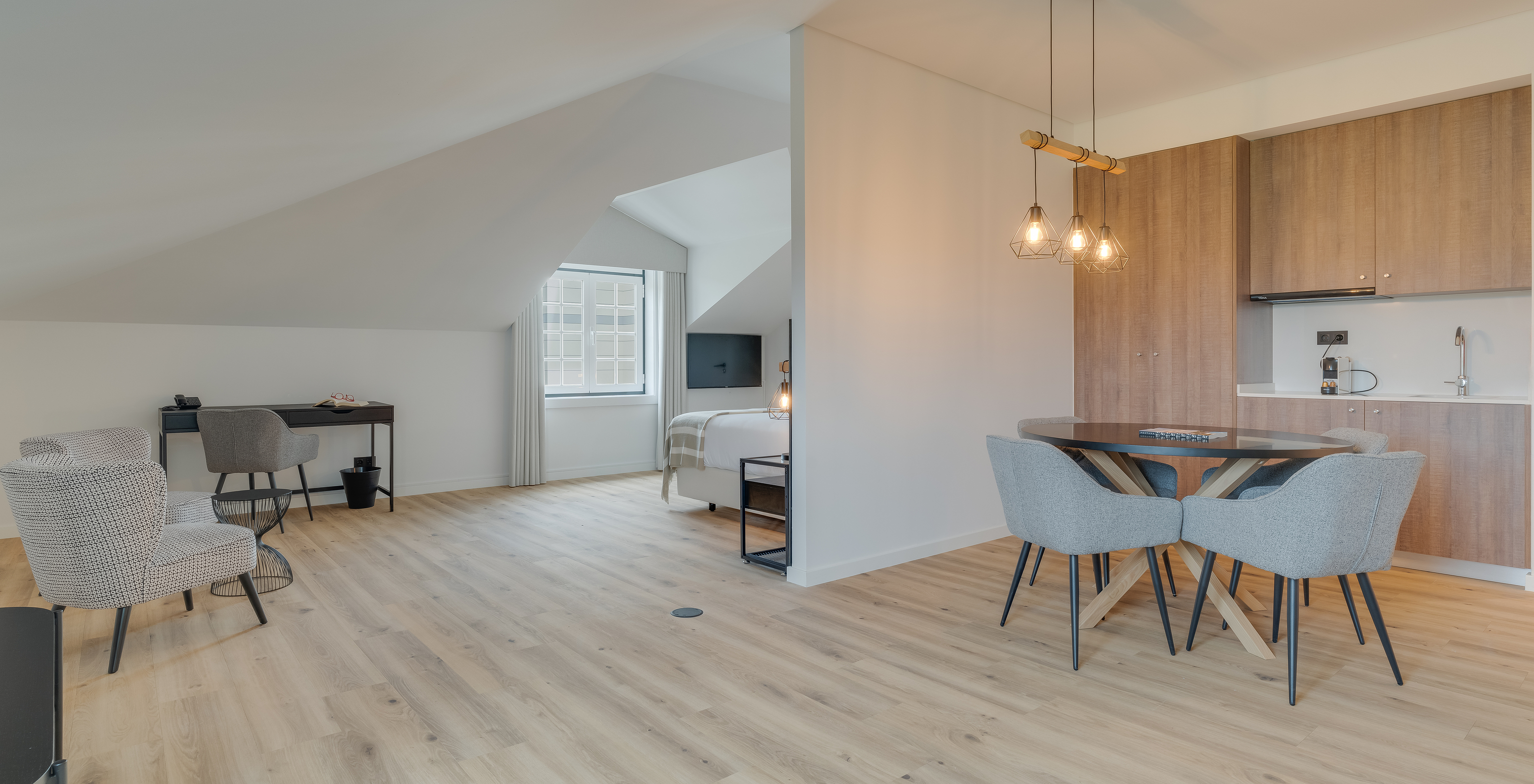 The Suite - Clubhouse of Pestana Sintra Golf has a kitchenette, a dining table, two armchairs, and a desk