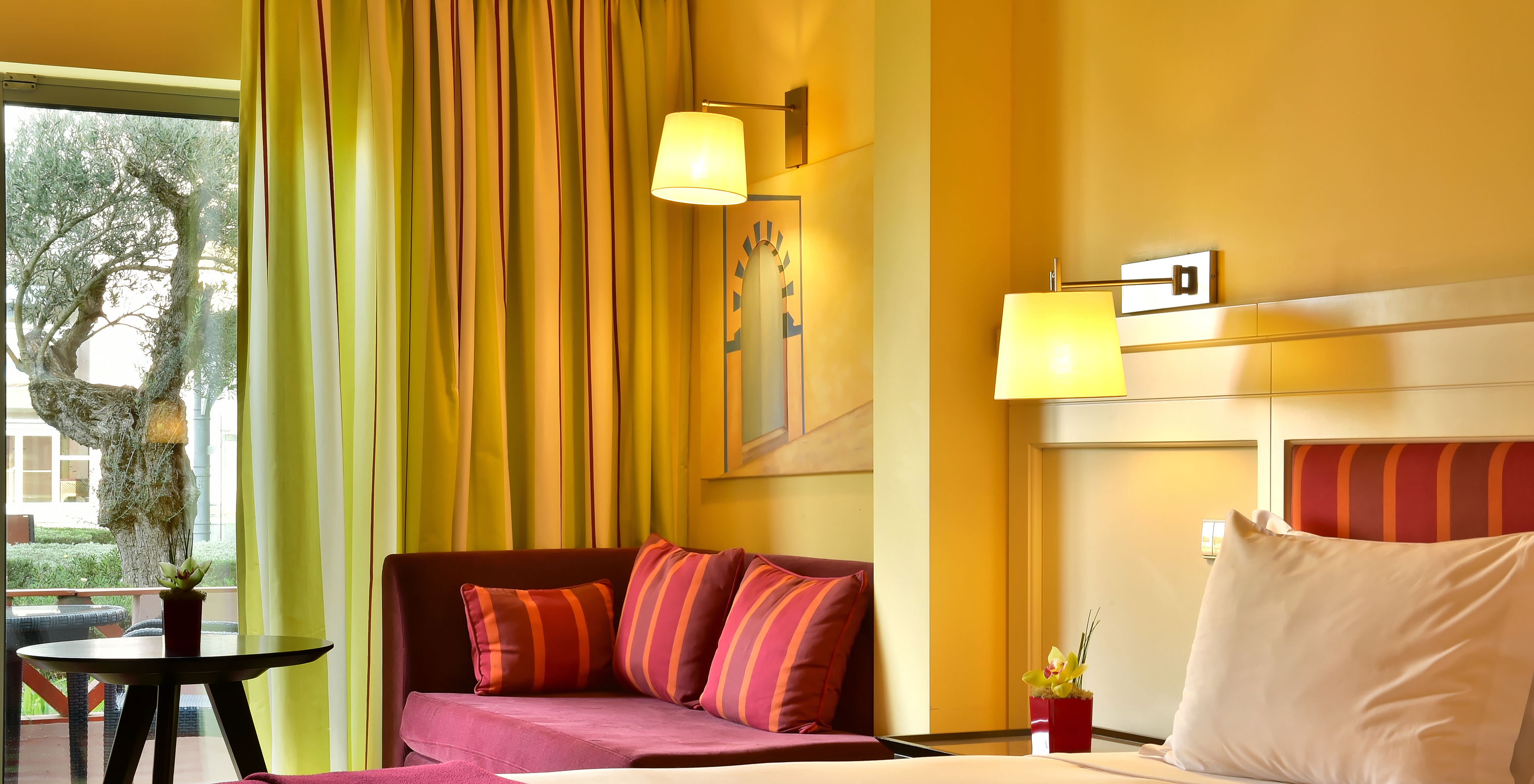 The Superior Double of Pestana Sintra Golf has two beds, a sofa with a coffee table, and a window with curtains