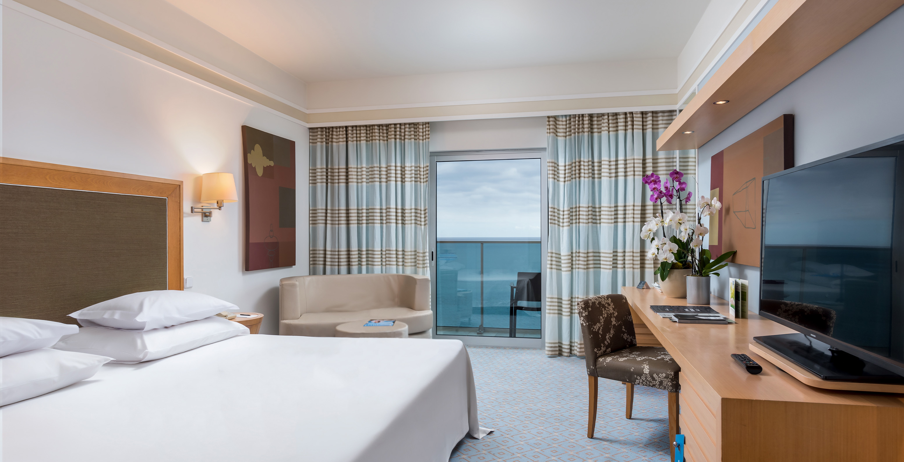 The Superior Classic Double Room with Sea View at Pestana Carlton Madeira has a double bed, a TV, a desk, and a balcony