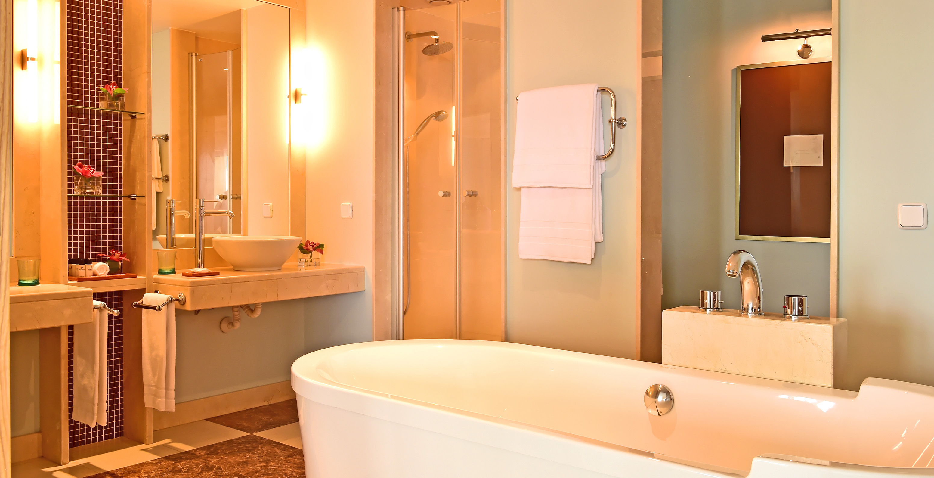 The Junior Suite at Pestana Carlton Madeira has a bathroom with a bathtub, sink, and decorative elements