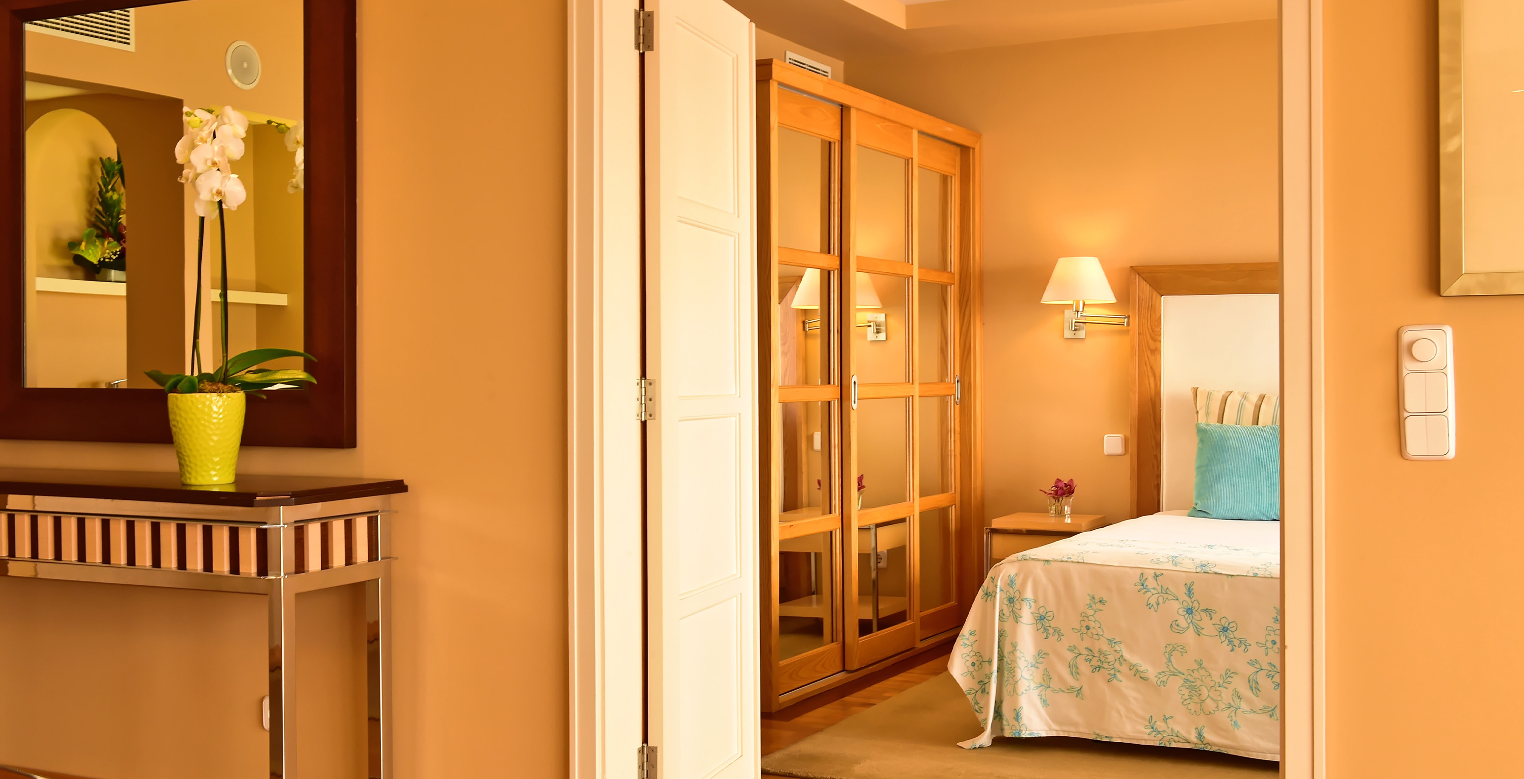 The Presidential Suite at Pestana Carlton Madeira has a double bed and a wardrobe lined with mirrors