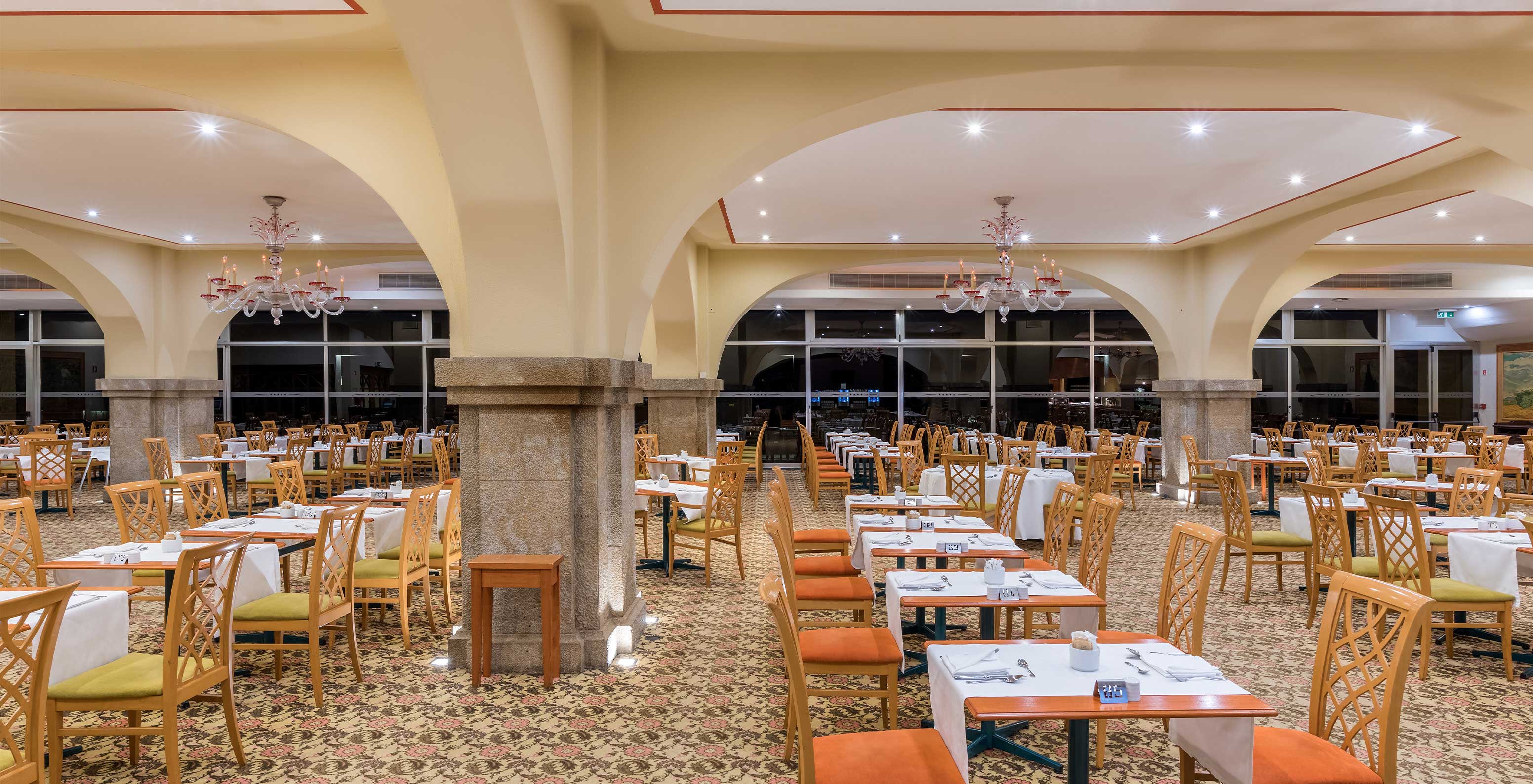 The Arcos restaurant in Madeira has a floral carpet and several set tables