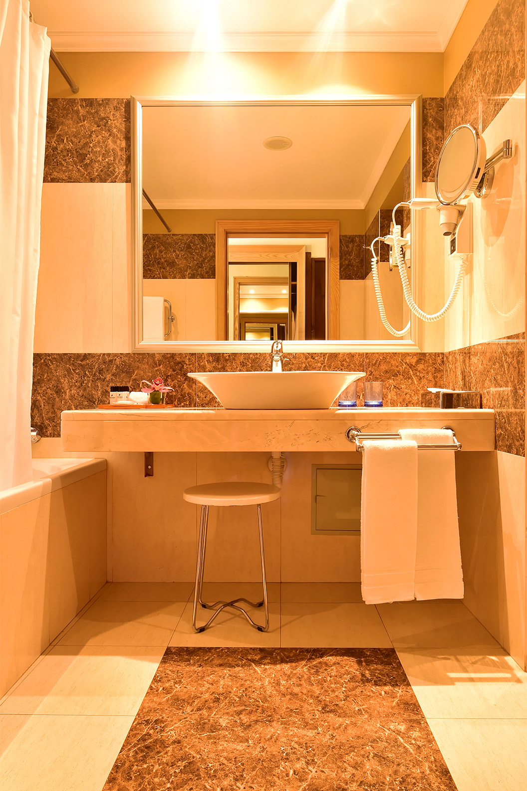 The Classic Double Room with Pool View at Pestana Carlton Madeira has a bathroom with brown tiles and a bathtub