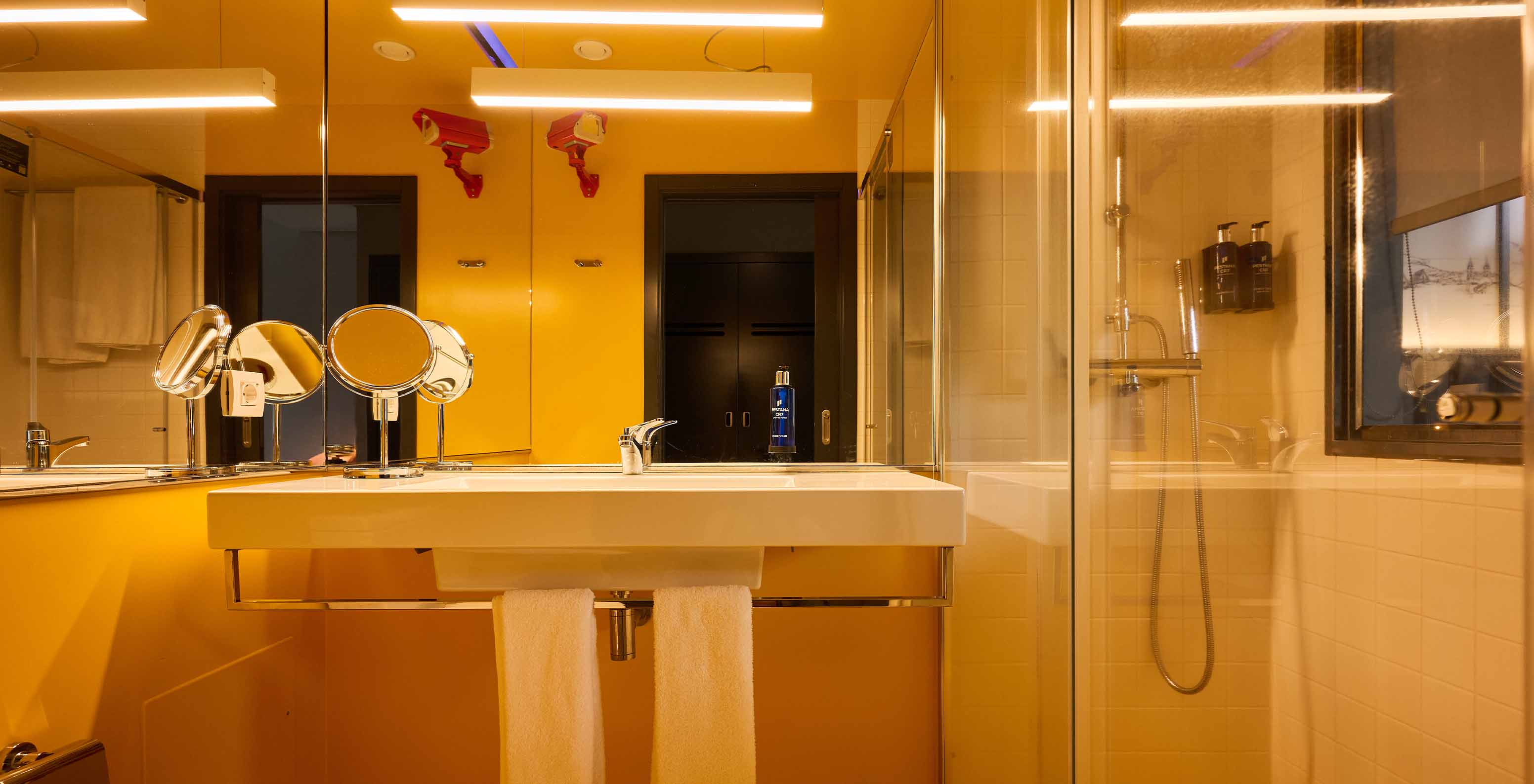 The CR7 Room at Pestana CR7 Funchal features a modern yellow bathroom with a shower