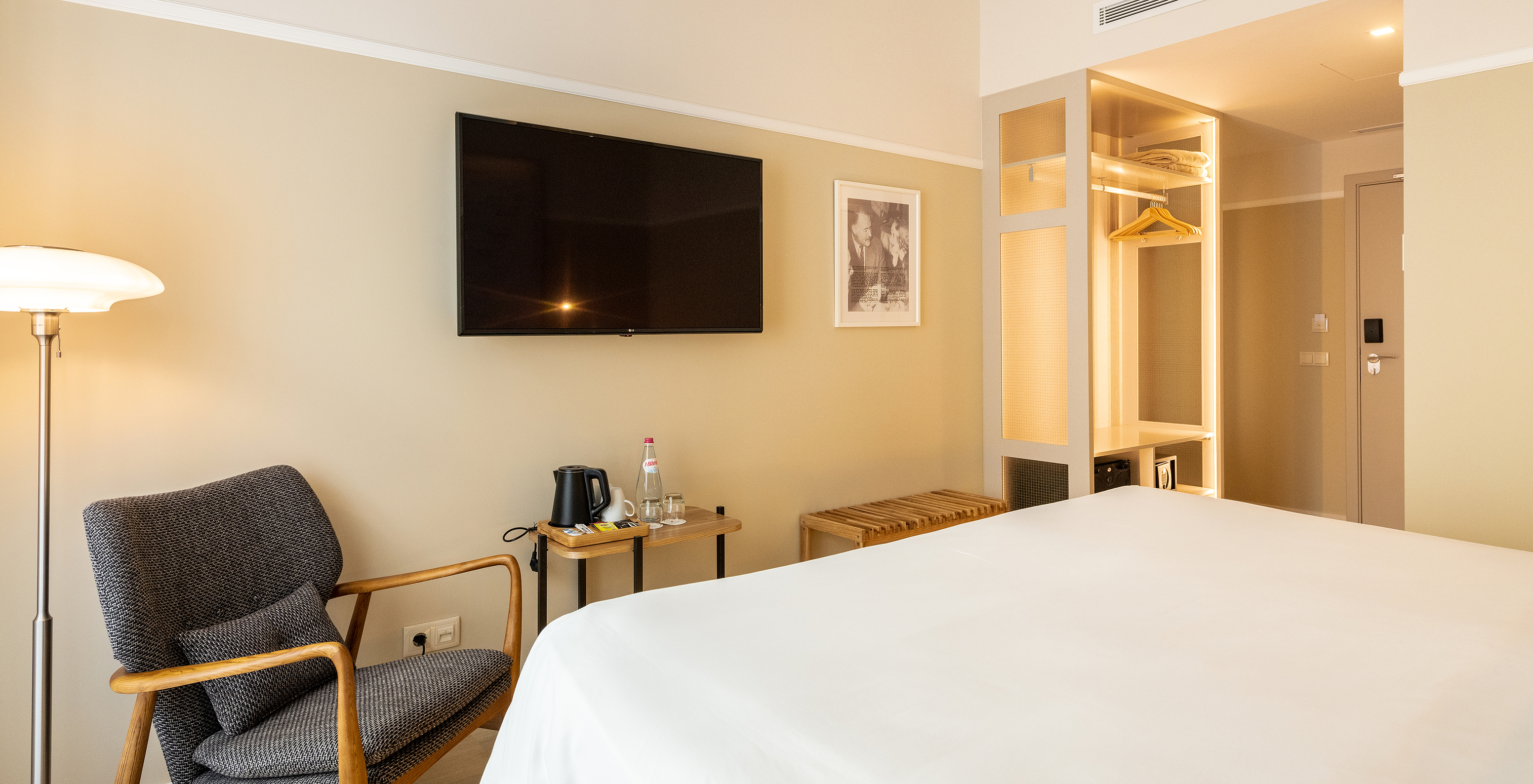 The Comfort room at Pestana Fisherman Village includes a wall-mounted television facing the bed and a wardrobe without doors