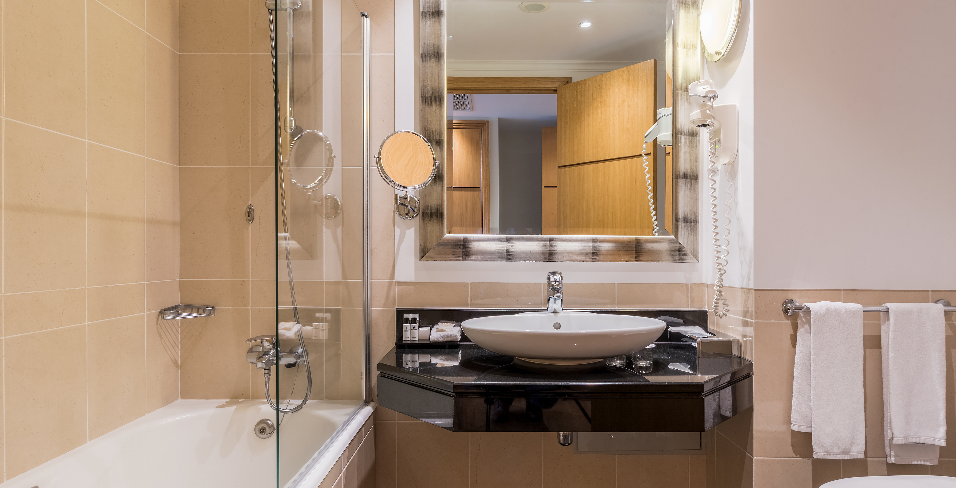 The Twin Superior Sea View Room at Pestana Grand has a bathroom with sink, bathtub with shower and towel