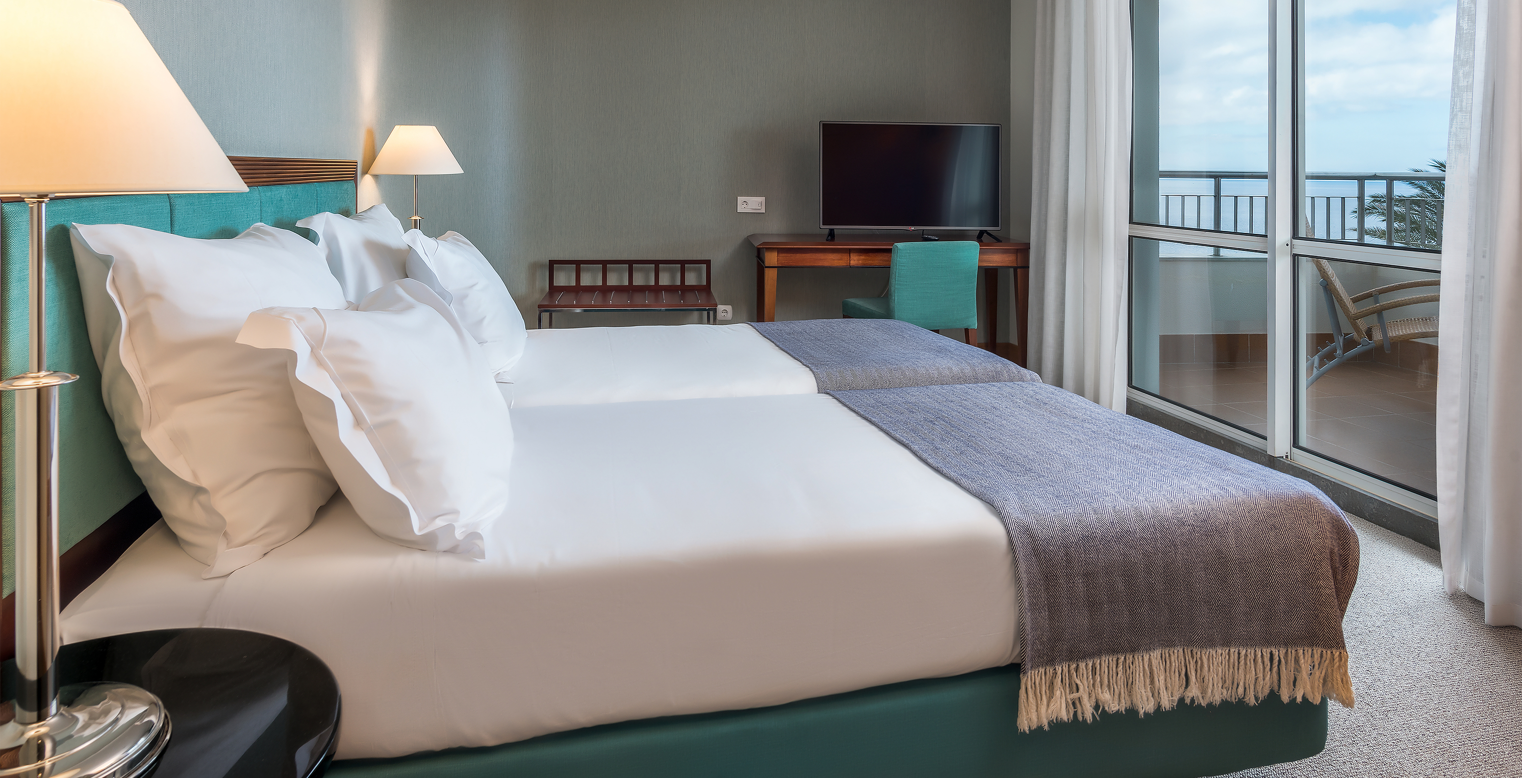 The Standard Suite Sea View at Pestana Grand has two single beds, TV and desk