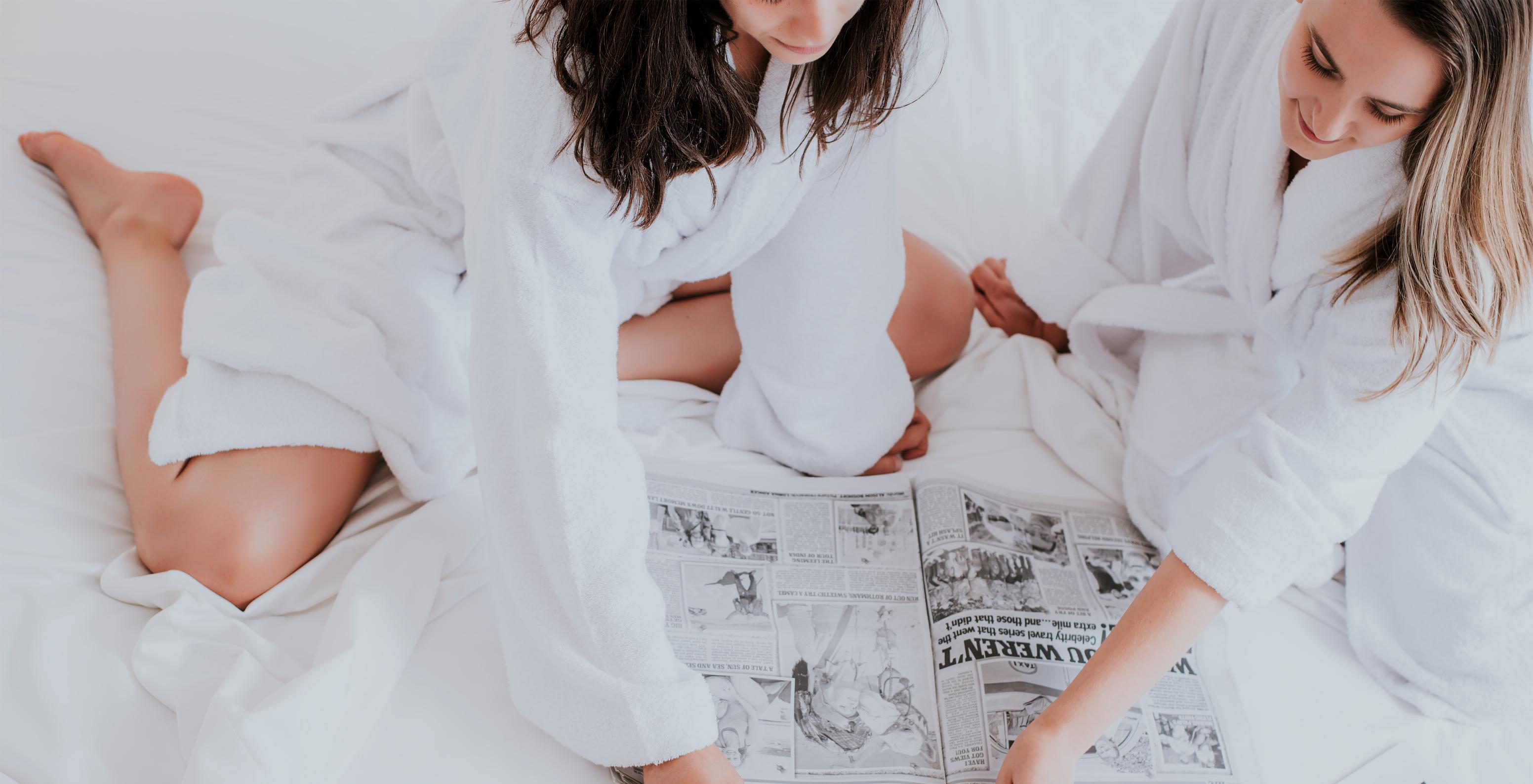 The T0 Studio at Pestana Madeira Beach Club has bathrobes available and a bed with newspapers and strawberries with chocolate