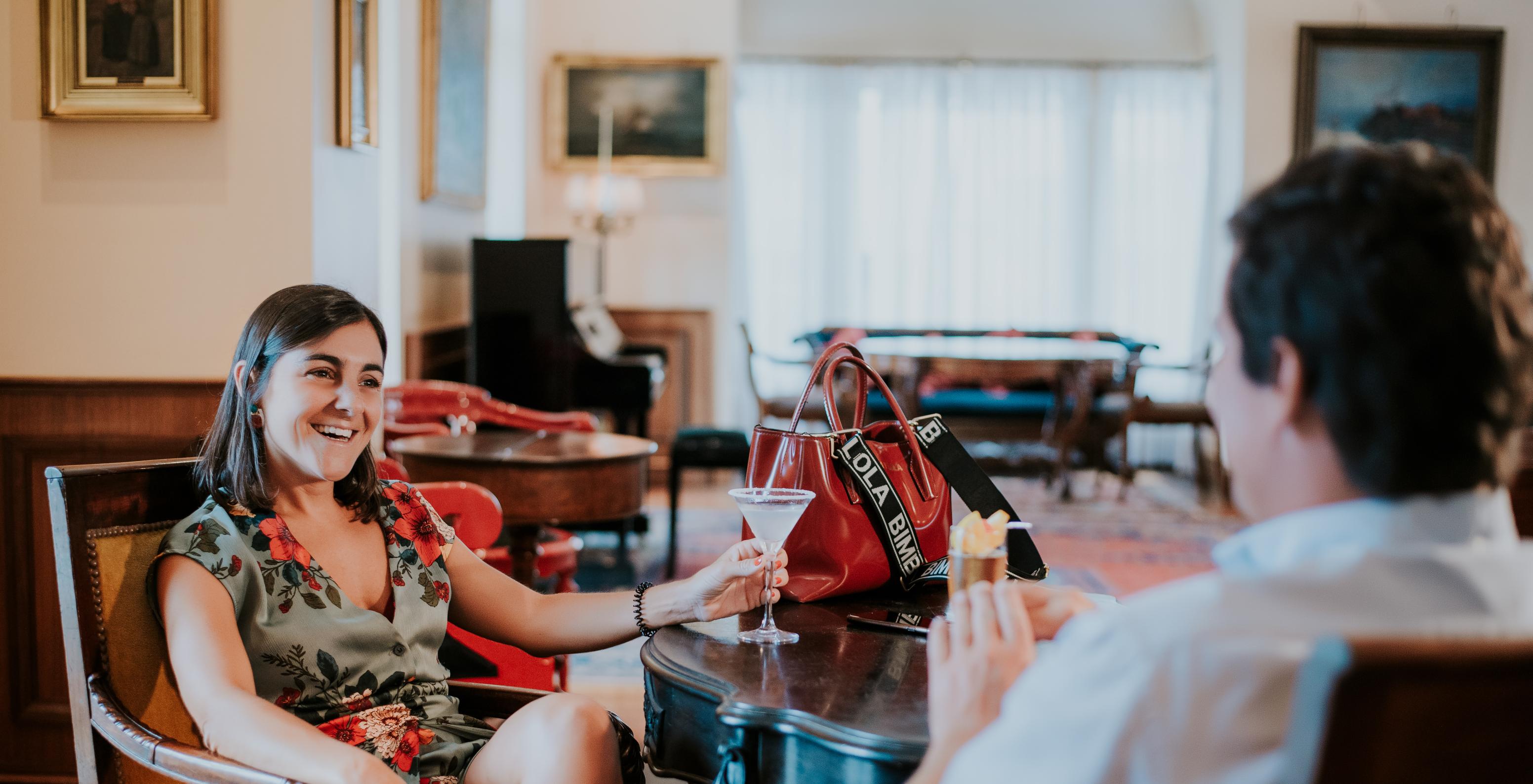 Two people chatting and drinking at the bar of Pestana Miramar, a hotel in Madeira near the beach