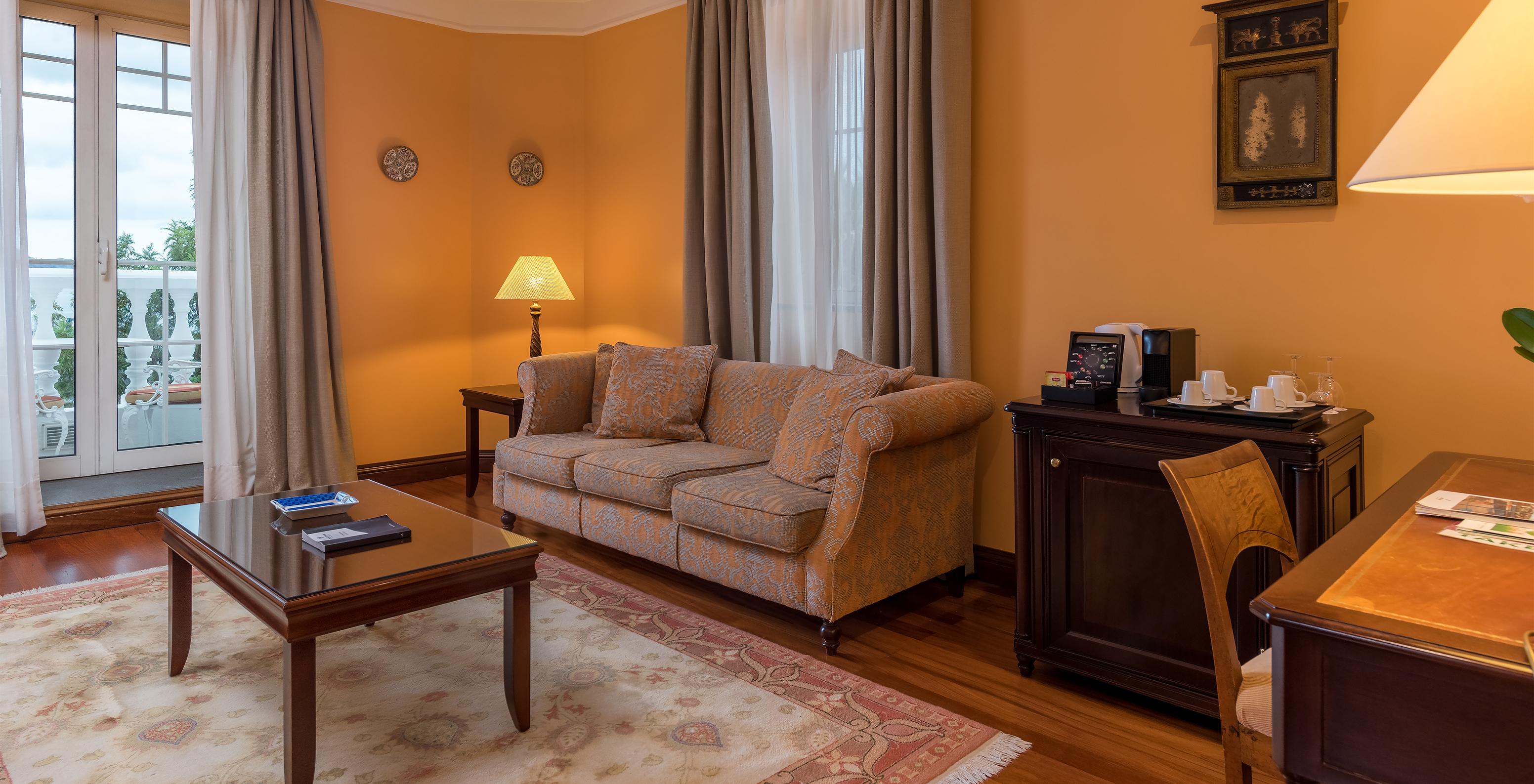 The Miramar Suite at Pestana Miramar has a seating area, with a sofa, coffee machine, kettle and a desk