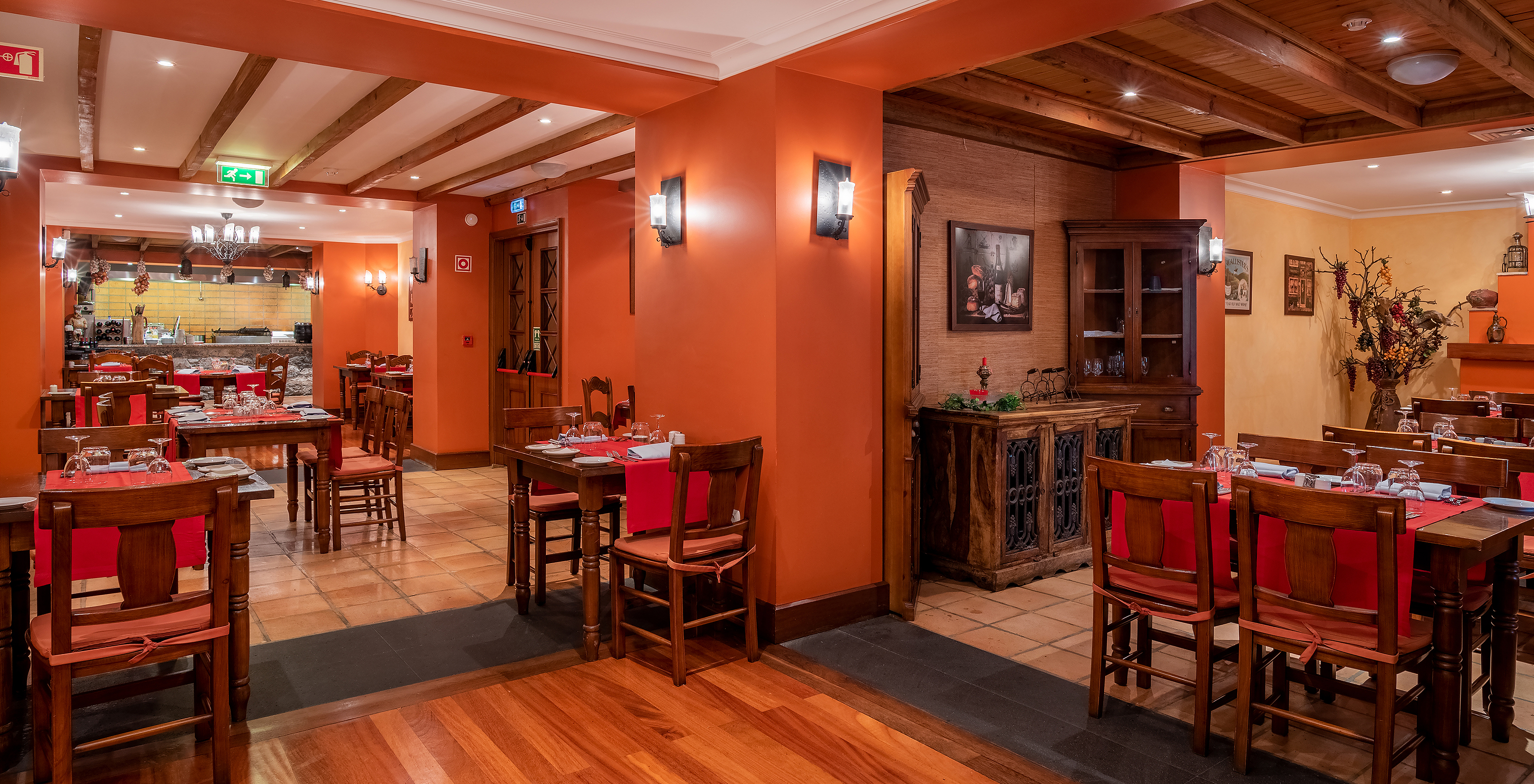 The Adega Madeirense restaurant at the 4-Star Hotel in central Funchal features vintage decor and orange walls